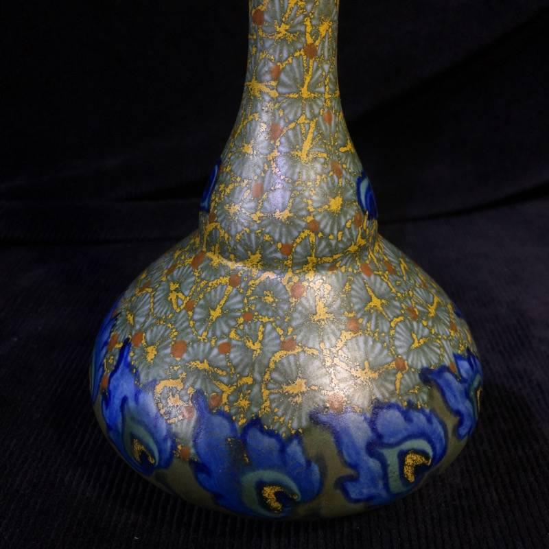 Gouda vase with 'Merapi' pattern of flowerheads on a yellow ground, a frieze of blue flowers to the base and neck. Well marked to the base, with 'HOLLAND' but no 'GOUDA', circa 1925.
 