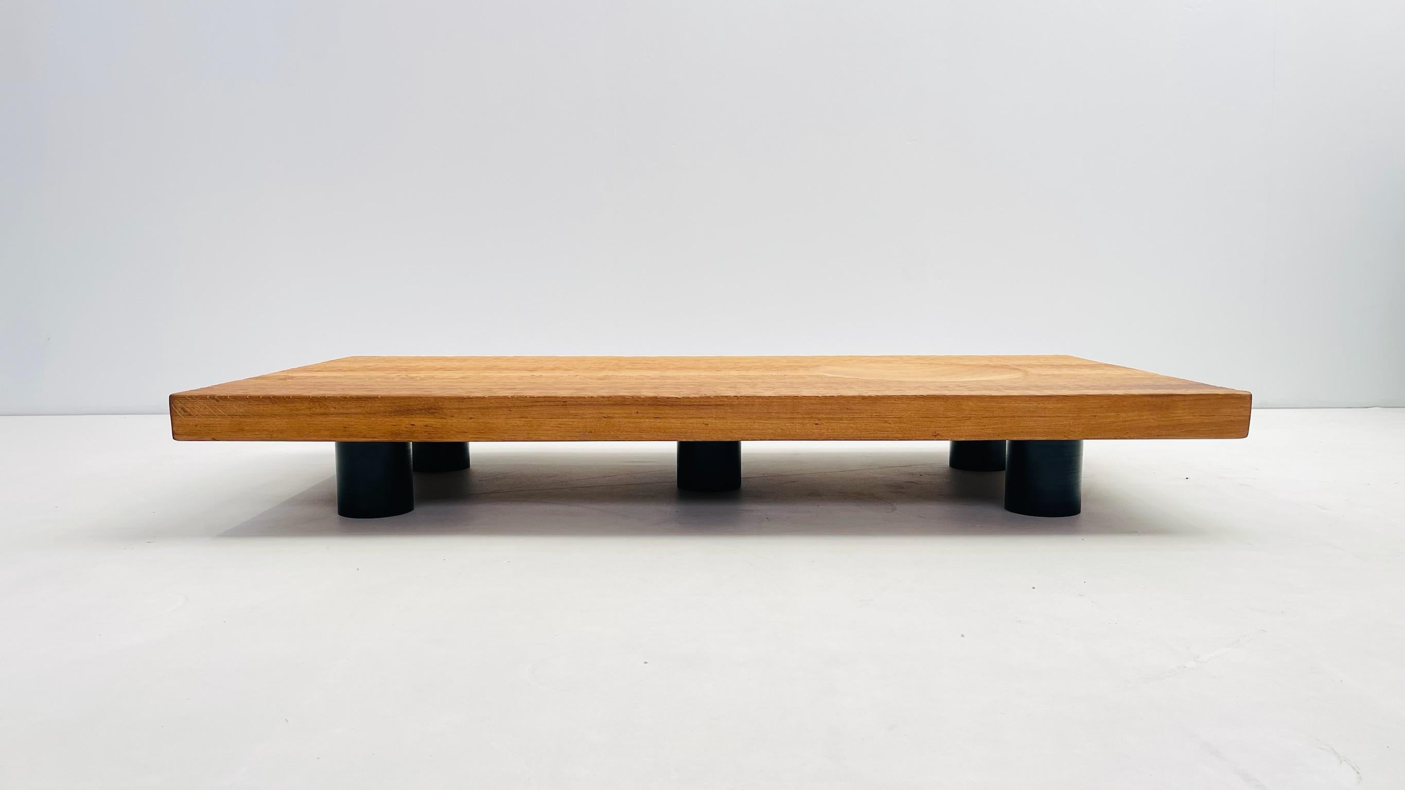This low coffee table inspired by the japaneses zen rock gardens is a creation we made through things we got in our workplace. The table top is an old oak we've meticulously gouged as a grid of tiny waves. It is tempting to run your hand over it,