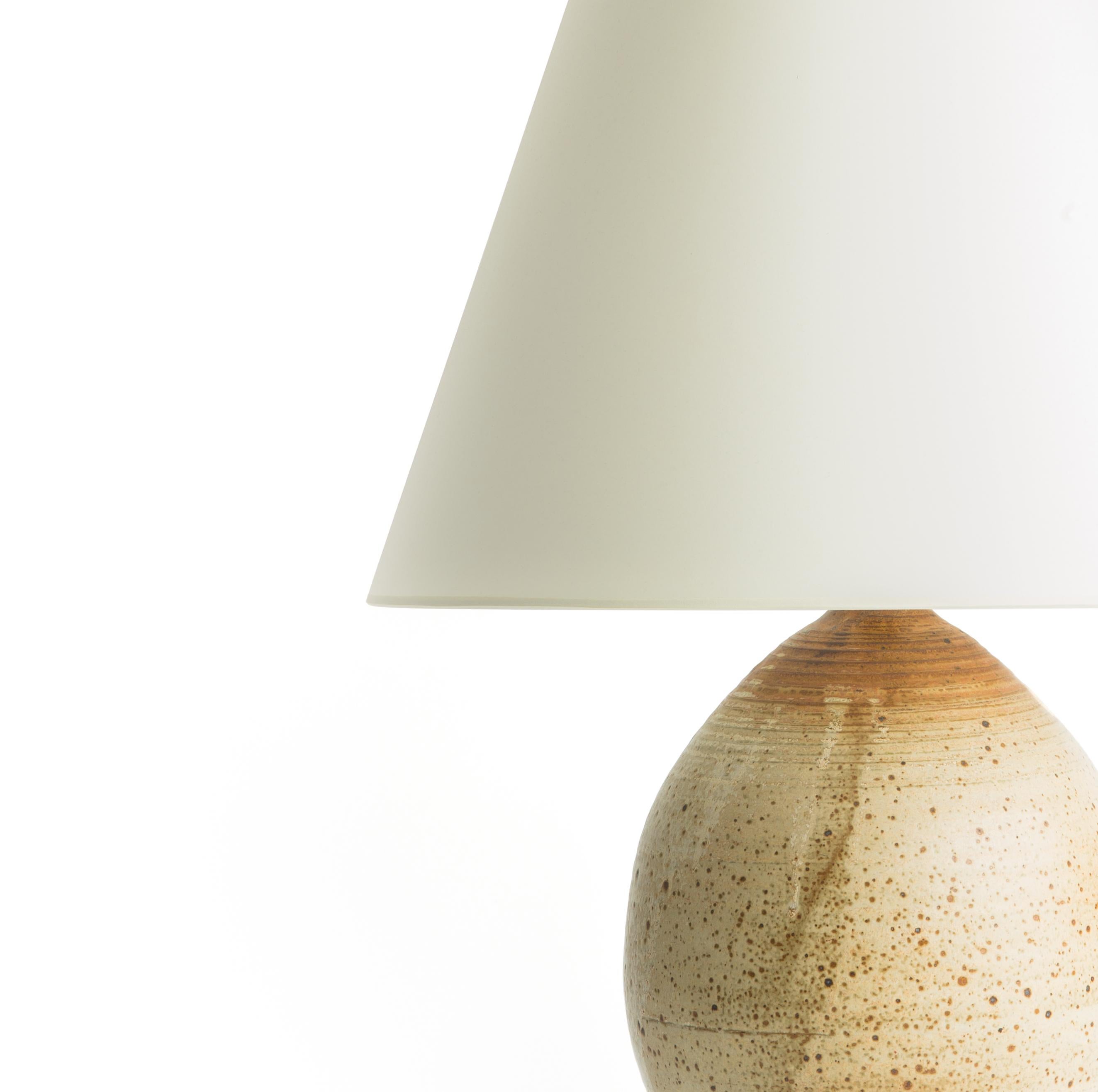 Gourd ceramic table lamp with textured surface.

Custom burnished nickel base fitted to the base.

Wired to US standards with rotary dimmer switch, braided cloth cord.

Shade not included.