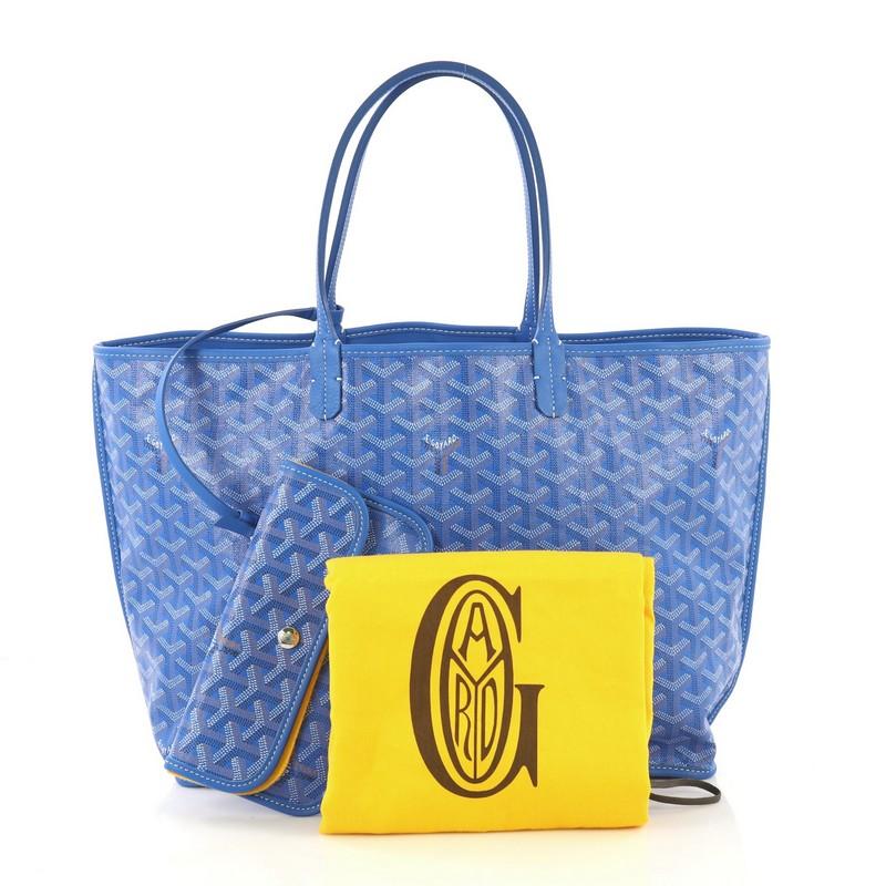 This Goyard Anjou Reversible Tote Coated Canvas PM, crafted in blue coated canvas, features dual flat leather handles, leather trim, and silver-tone hardware. It opens wide to a blue leather interior. 

Condition: Excellent. Minor wear on base