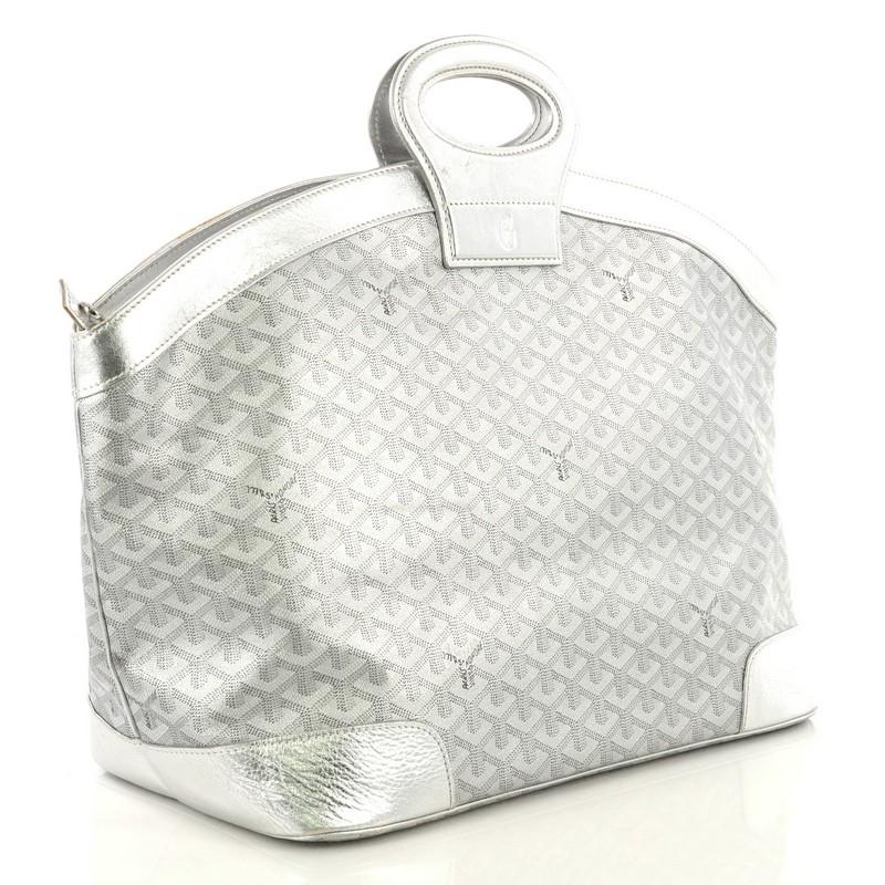 This Goyard Beluga Bag Coated Canvas MM, crafted in silver coated canvas, features leather top ring handles and silver-tone hardware. Its zip closure opens to a yellow fabric interior with zip pocket. 

Estimated Retail Price: $3,550
Condition: