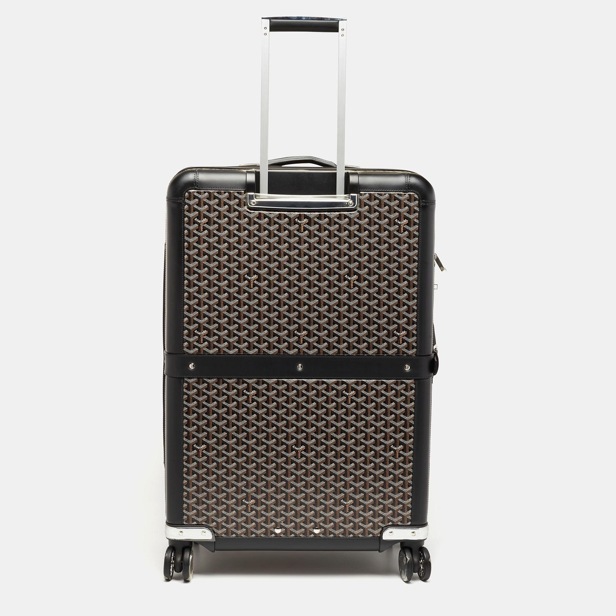 This Satolas GM Rolling suitcase from the House of Goyard is super sturdy, practical, and stylish for long vacations. Crafted from black Goyardine canvas, this suitcase displays silver-tone fittings, a sturdy trolley handle, and a spacious lined