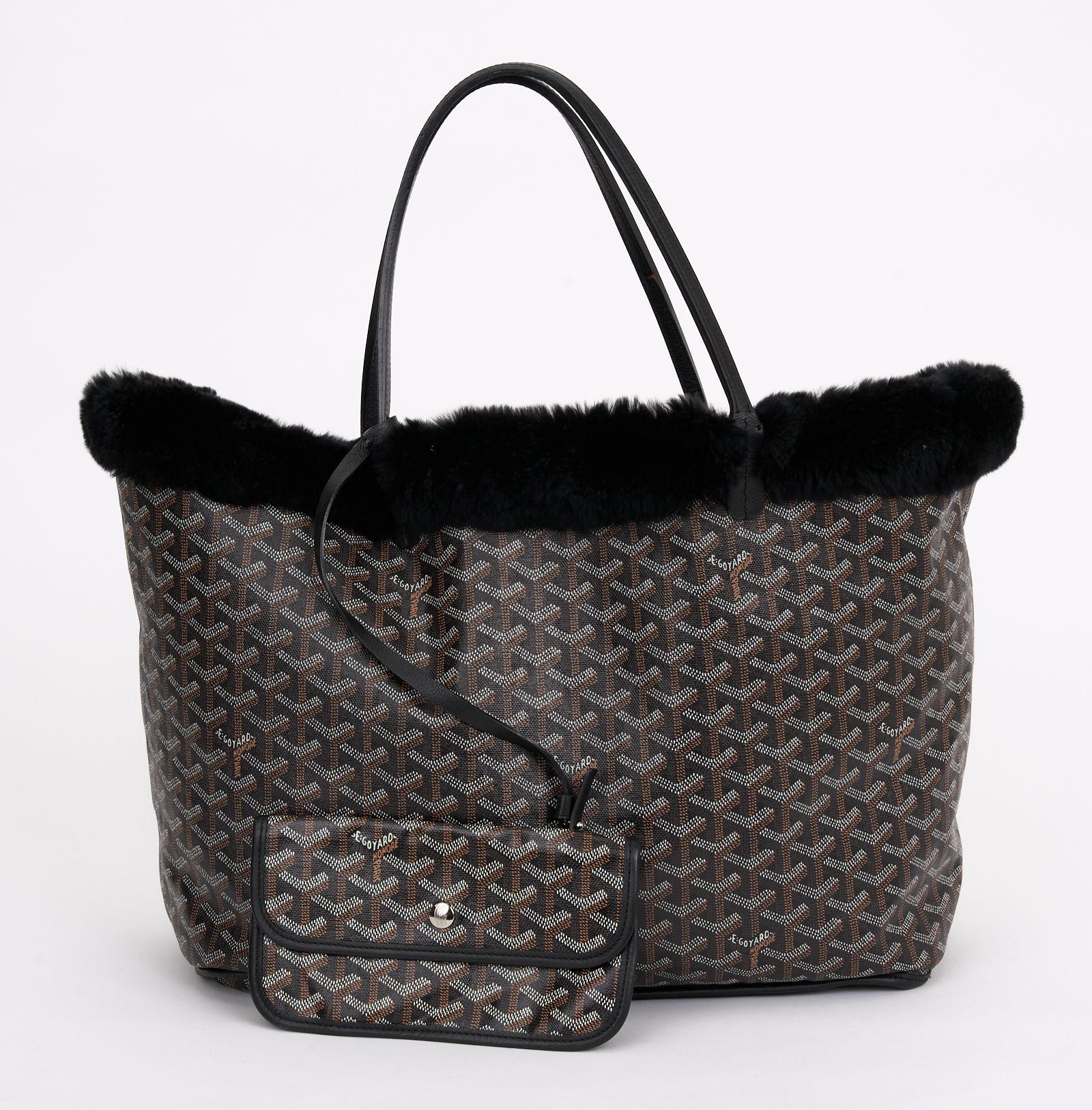 This Limited Edition Goyard Rex Fur large tote is crafted of a traditional Goyard chevron monogram on black coated canvas with fur. The tote features black leather trim and top handles. The top opens to a black fur interior with a removable