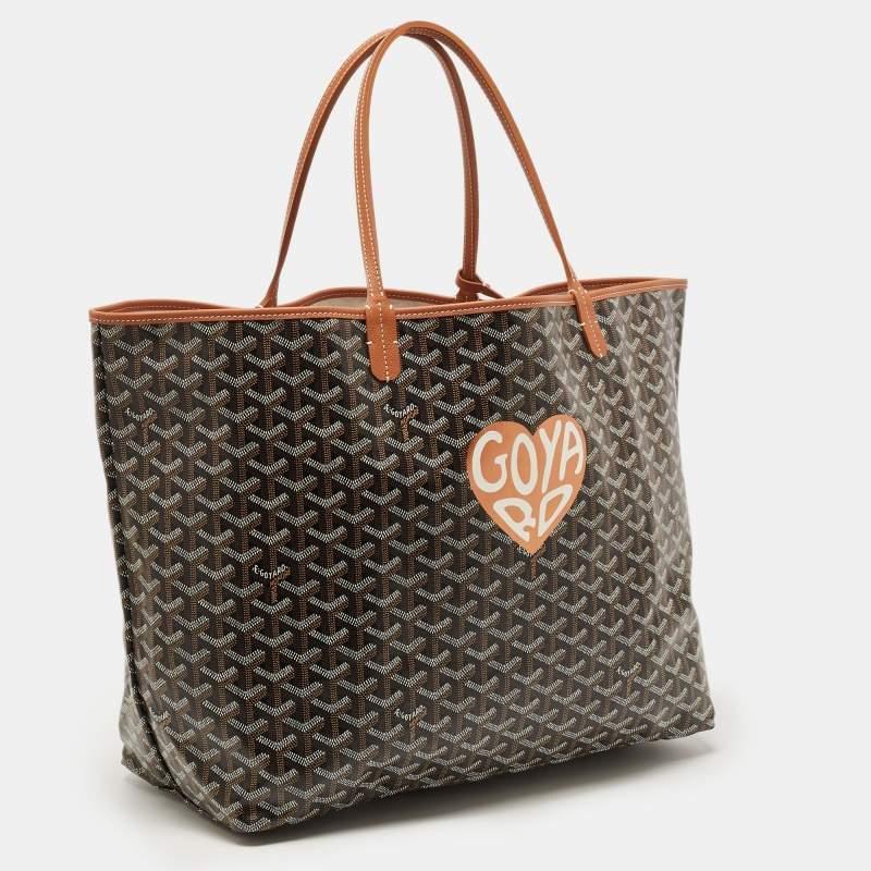 The Goyard Saint Louis GM tote is a luxurious and spacious tote bag. It features the iconic Goyardine pattern in brown on durable coated canvas, complemented by leather trim. The bag's large size makes it perfect for carrying essentials with style