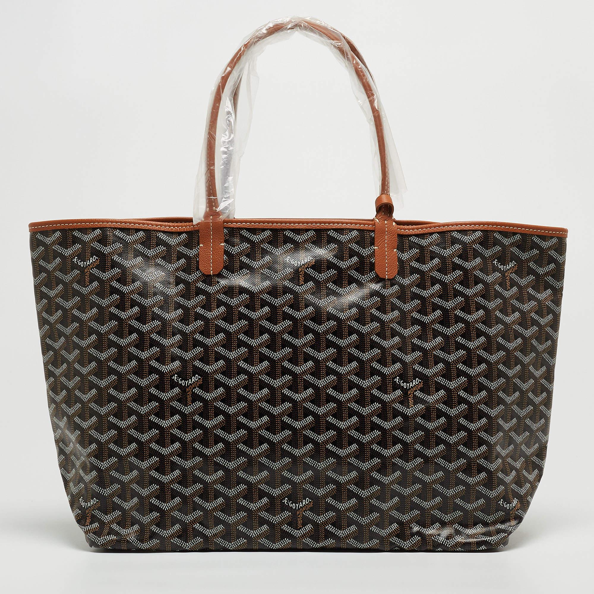 A charming creation by Goyard, this Saint Louis tote is the result of impeccable construction and artistic design. It is created from the signature Goyardine-coated canvas and leather into a versatile silhouette. With a perfect combination of
