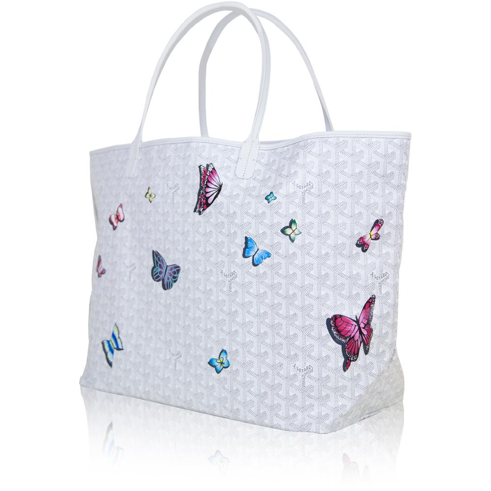 A handbag to truly set your heart aflutter, this white Monogram St Louis tote Bag was crafted from Goyardine Canvas, a coloured textile made from cotton, linen and hemp, and vitalised by a flurry of hand-painted butterflies, in a mix of refined