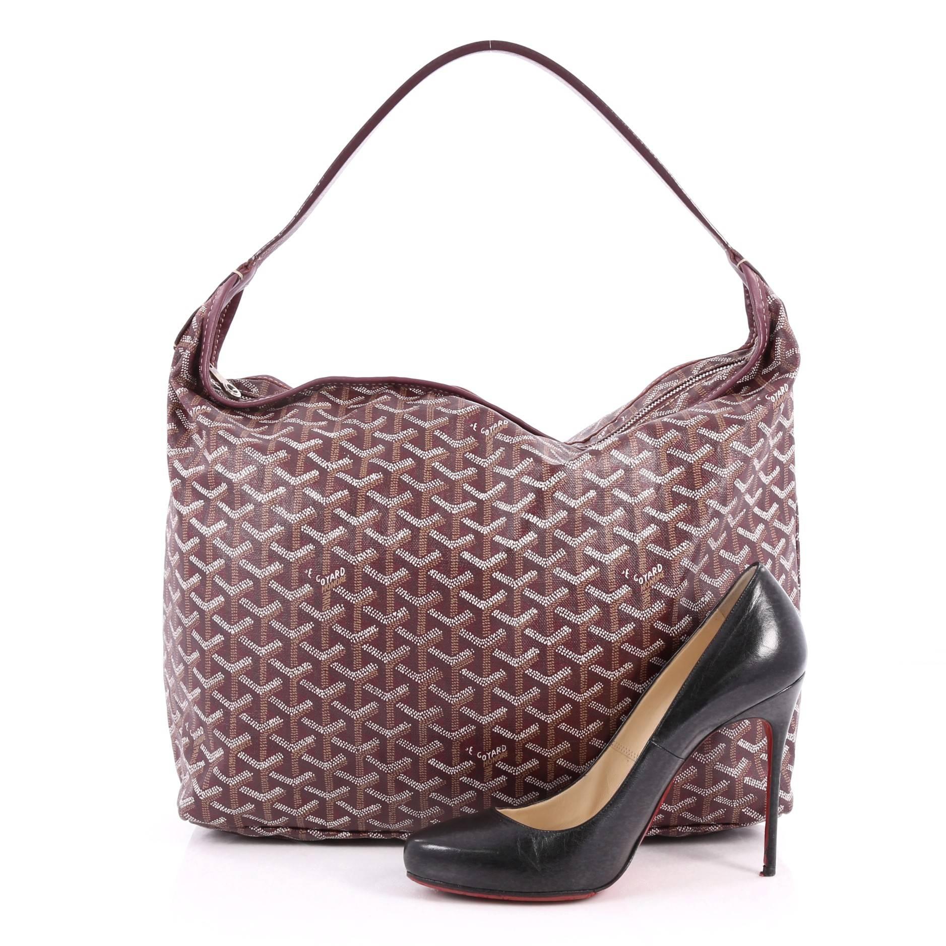 This authentic Goyard Fidji Hobo Coated Canvas is a blend of luxury and casual sophistication. Crafted from purple Goyardine chevron coated canvas, this bag features a flat leather handle, purple leather trims, and silver-tone hardware accents. Its