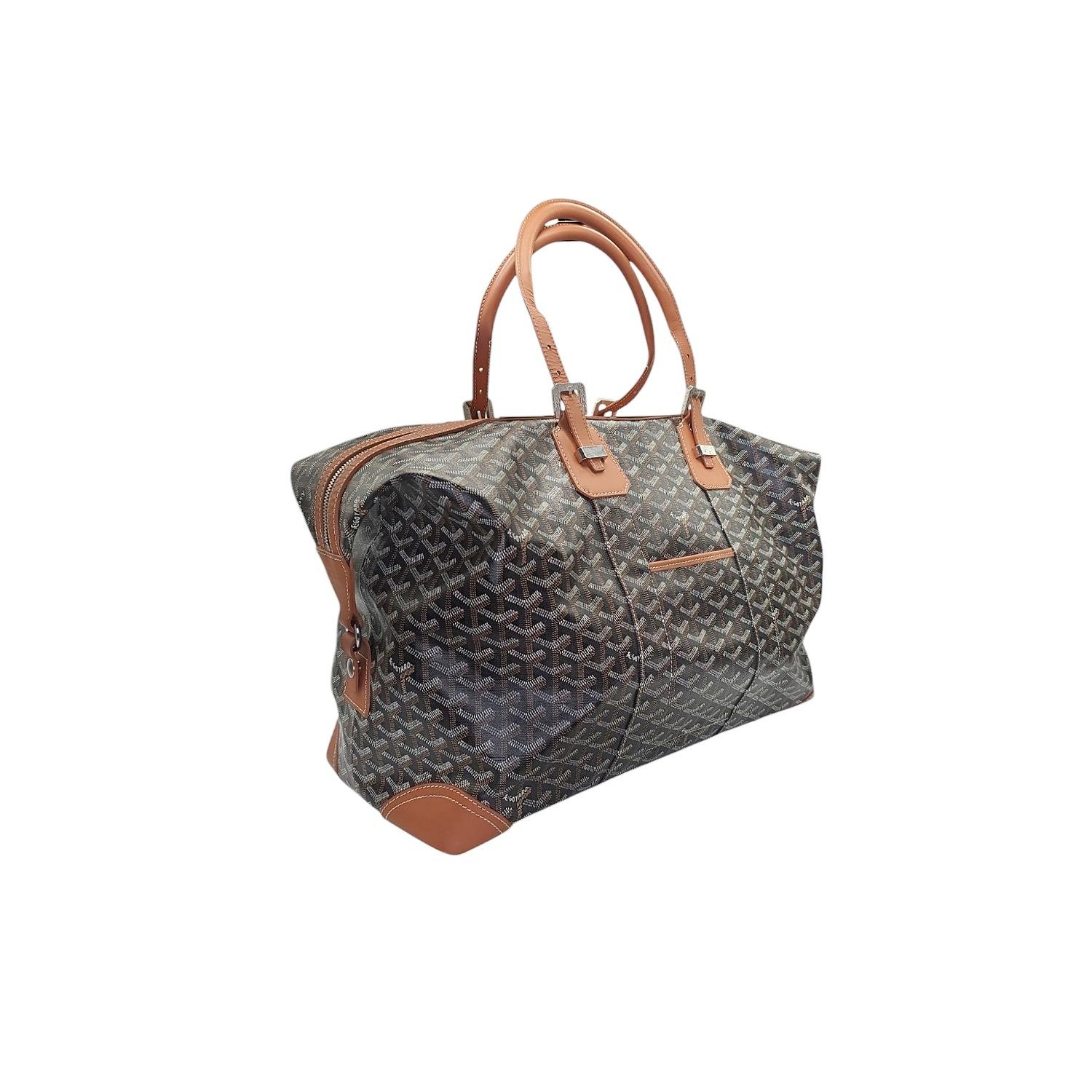 This luxurious and highly sought-after bag is crafted from Goyard's signature Goyardine coated canvas, known for its durability and distinctive hand-painted chevron pattern.  Accented with rich calfskin leather trim and polished silver-tone