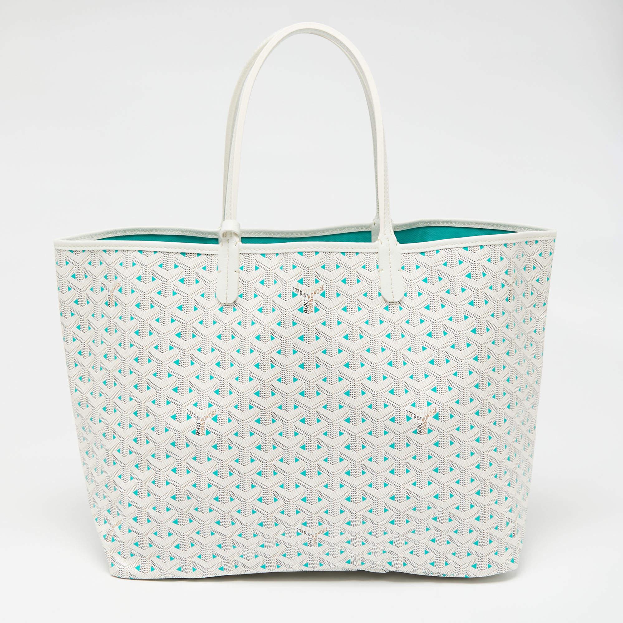 A charming creation by Goyard, this Saint Louise Claire Voie tote is the result of impeccable construction and artistic design. It is created from the signature Goyardine coated canvas and leather and is impressive with its classy white shade. With