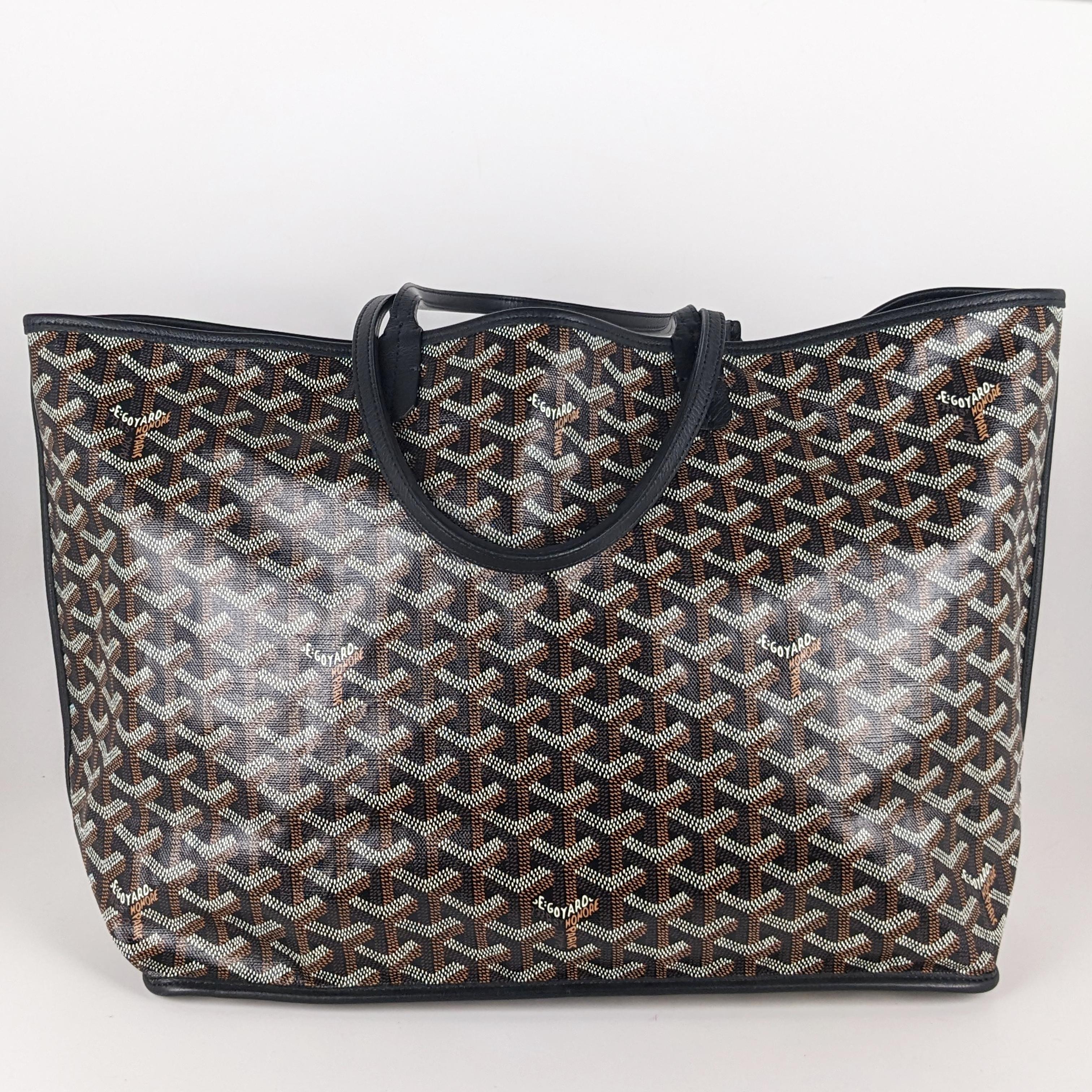 Condition: This authentic Goyard tote is in excellent condition. There is slight softening on the handles and very faint corner wear.

Includes: Removable pouch

Features: Goyard chevron on black canvas. The bag has a black leather trim along the