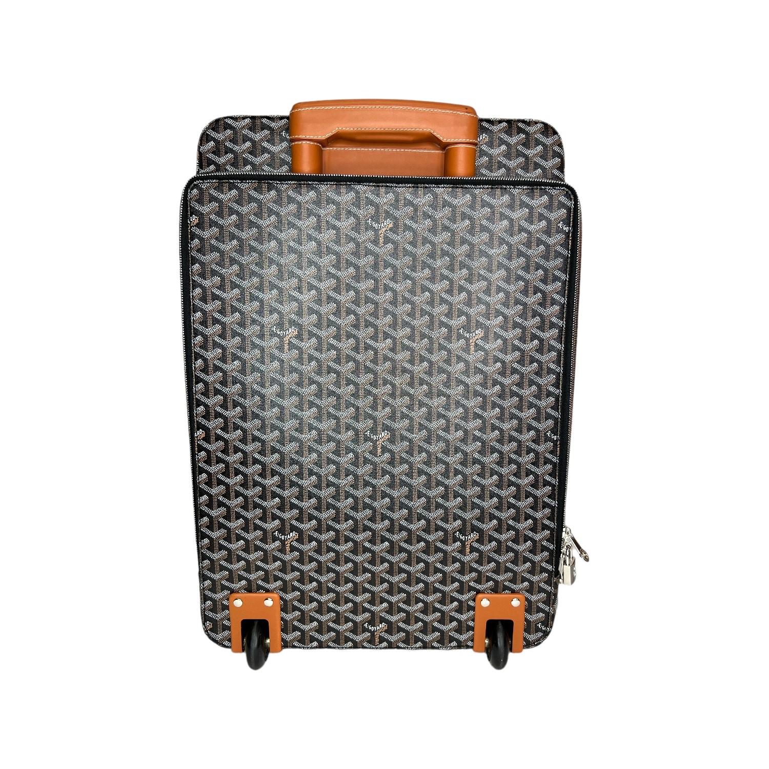 This Goyard Goyardine Trolley PM is finely crafted of the iconic Goyardine coated canvas exterior with leather trimming and palladium hardware features. It has 2 leather handles and there is also a retractable pull-handle. It has a zipped slip