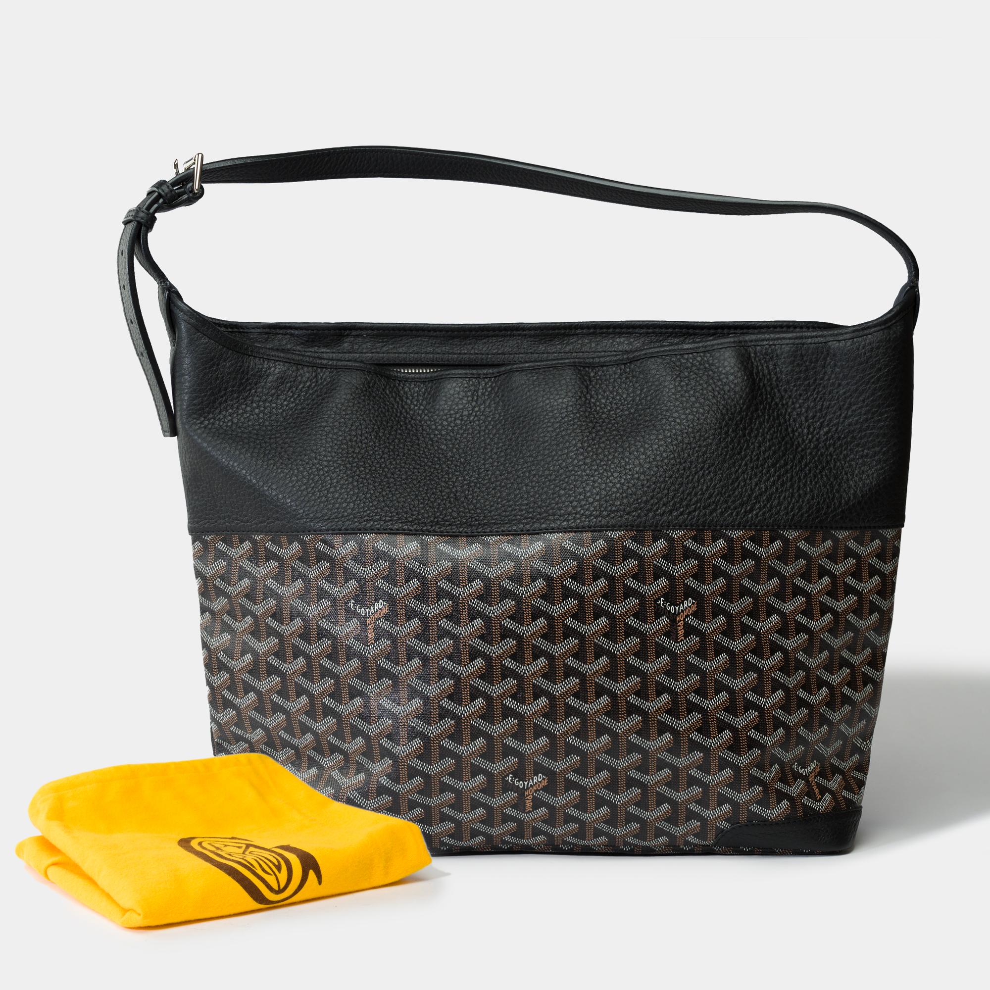 Goyard​ ​Grenadine​ ​Hobo​ ​bag​ ​in​ ​coated​ ​canvas​ ​and​ ​black​ ​leather​ ​and​ ​canvas​ ​Goyardine​ ​black​ ​and​ ​brown,​ ​silver​ ​metal​ ​trim​ ​and​ ​an​ ​adjustable​ ​shoulder​ ​strap​ ​in​ ​black​ ​leather​ ​allowing​ ​a​ ​shoulder​