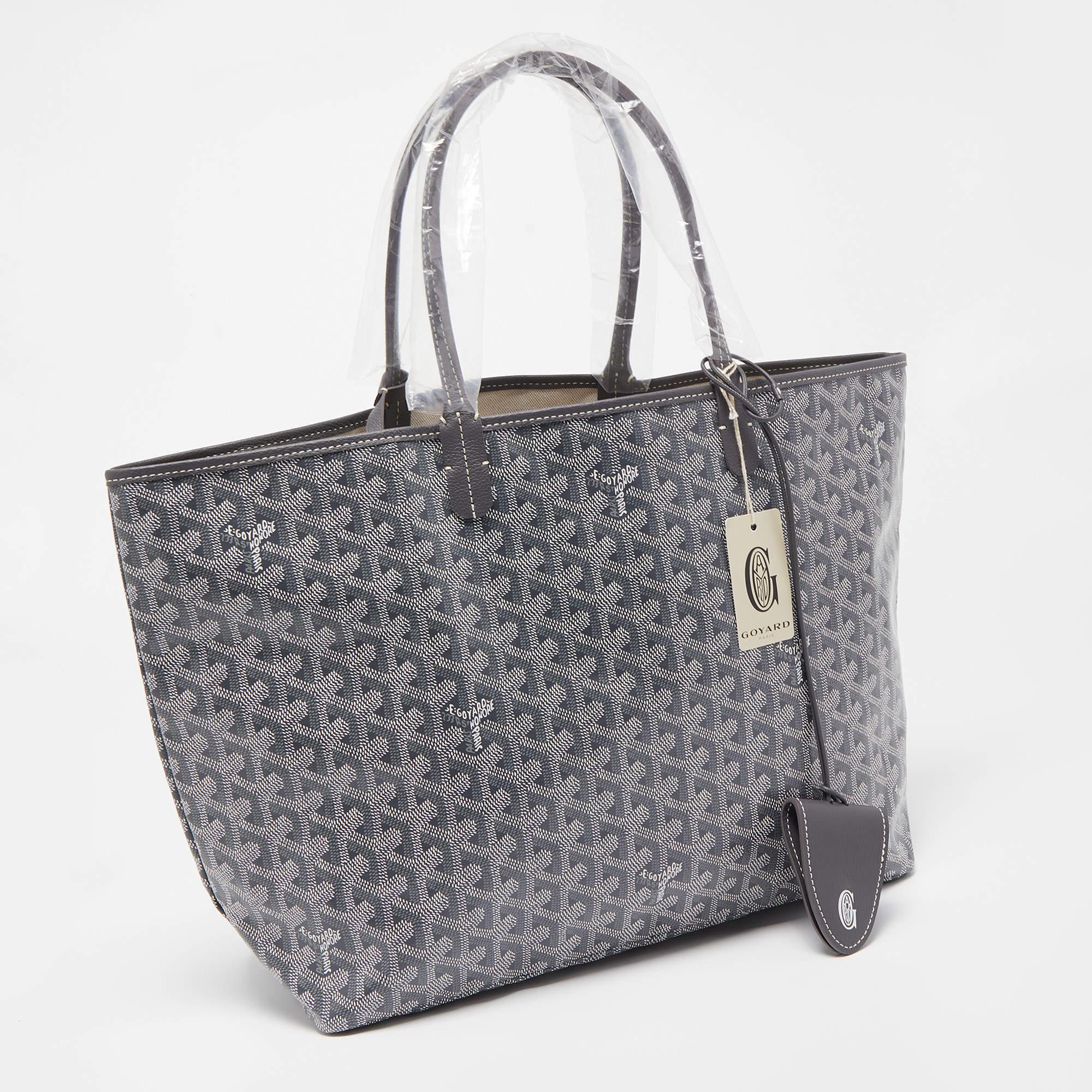 The Goyard Saint Louis tote is an elegant and versatile bag. It features the iconic Goyardine pattern on durable canvas, accented with leather handles and trim. The bag includes a handy bag clip for added convenience, making it a stylish and
