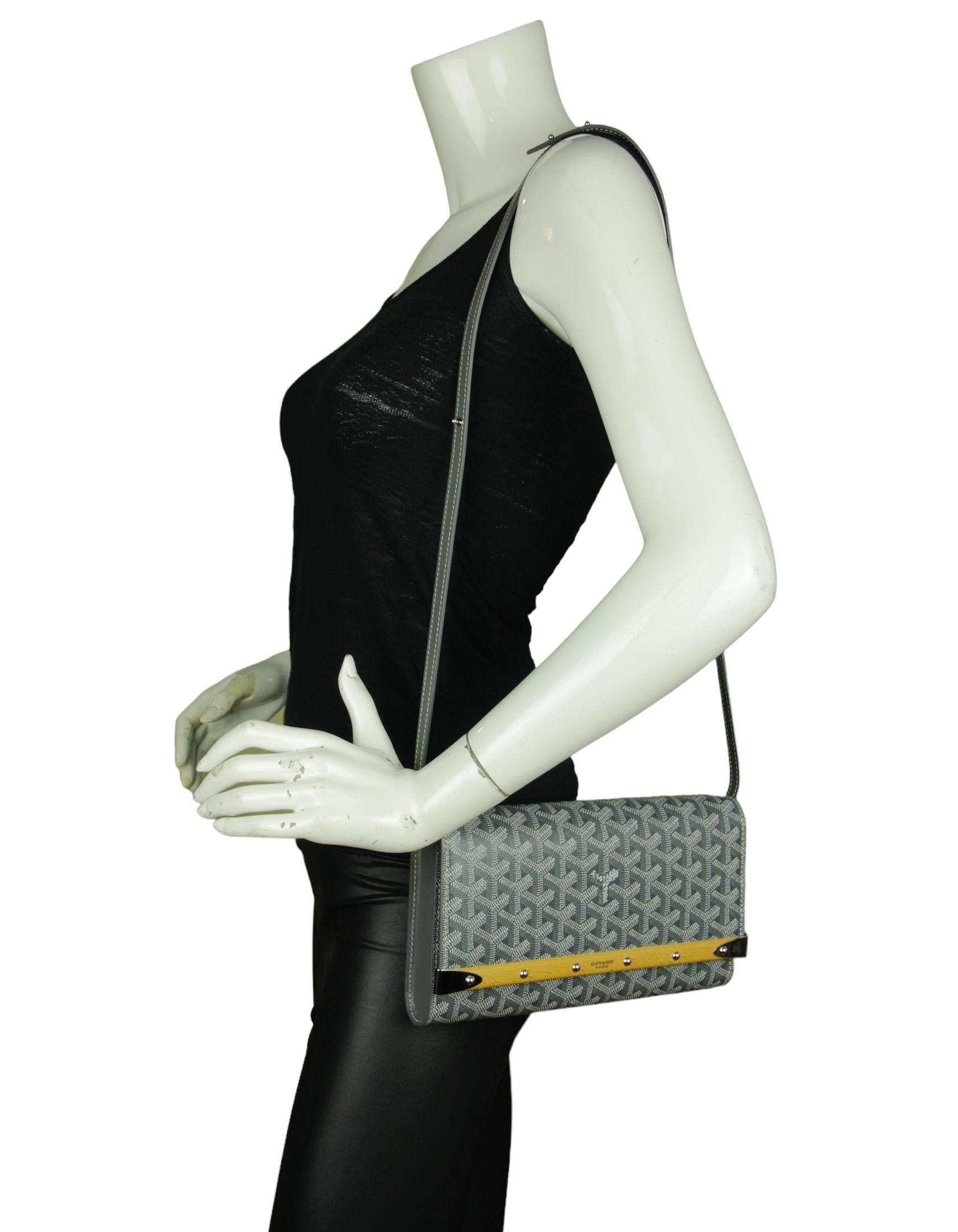Goyard Grey Goyardine Monte Carlo Bois Clutch Bag. Includes detachable strap. 

Made In: France
Color: Grey
Hardware: Silvertone
Materials: Coated canvas and leather
Lining: Canvas
Closure/Opening: Flap top with snap closure
Exterior Pockets: Back