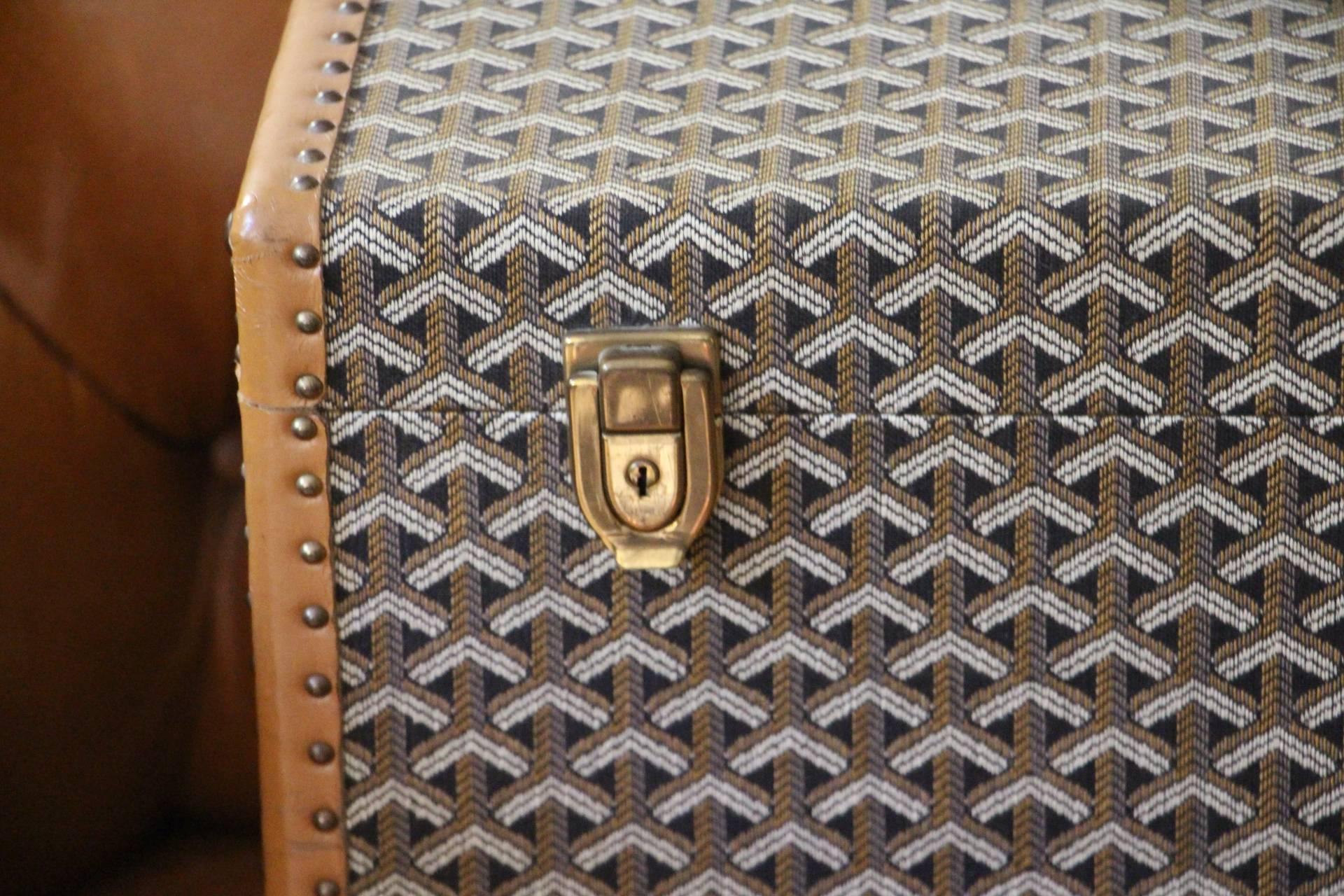 It is an extremely rare vintage jewelry case or train case made by Goyard. It features its famous 