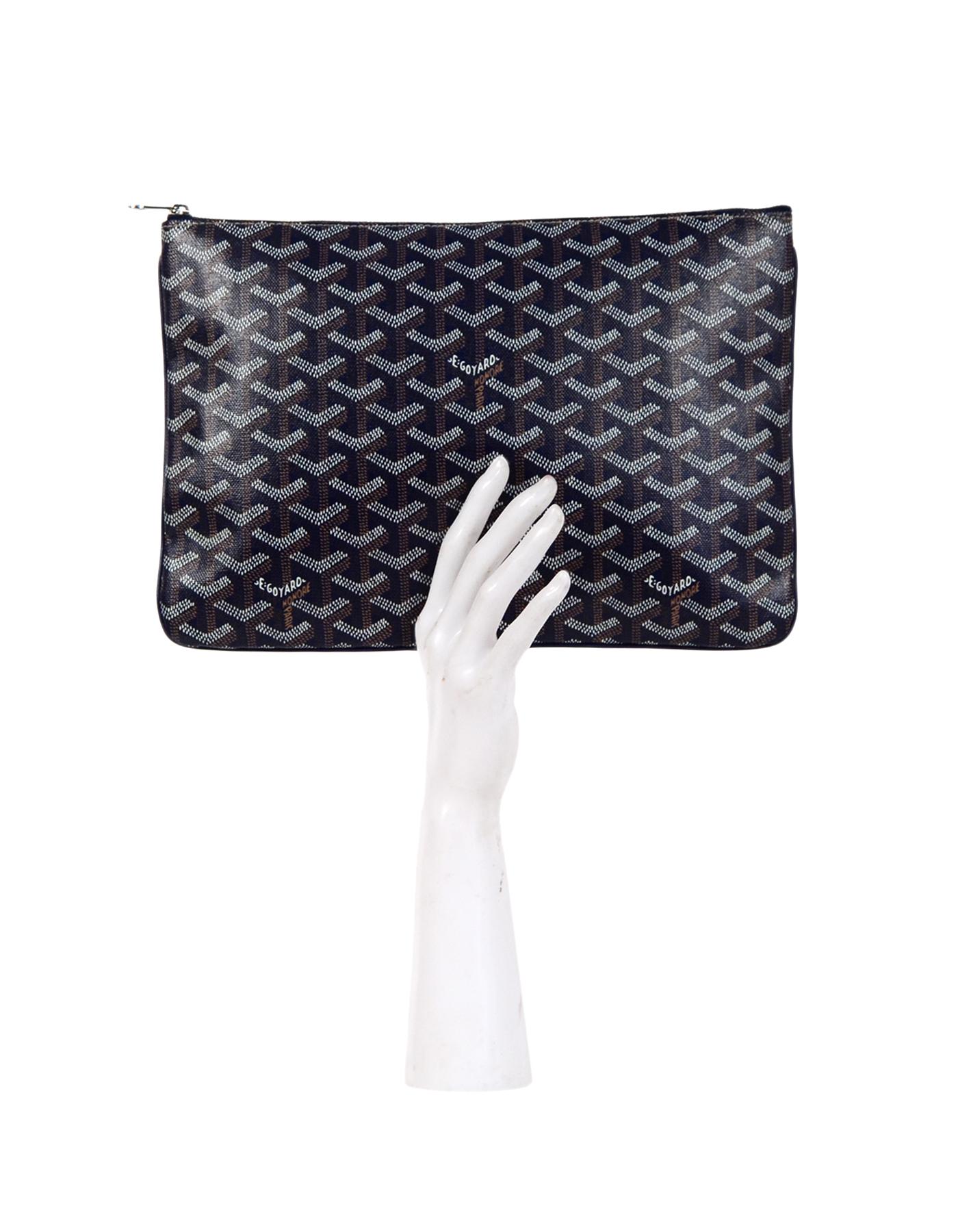 Goyard Navy Blue Goyardine Senat MM Zip Top Clutch

Made In: France
Color: Navy blue, tan, white
Hardware: Silver
Materials: Coated canvas, metal
Lining: Yellow canvas
Closure/Opening: Zip top
Exterior Pockets: None
Interior Pockets: One wall