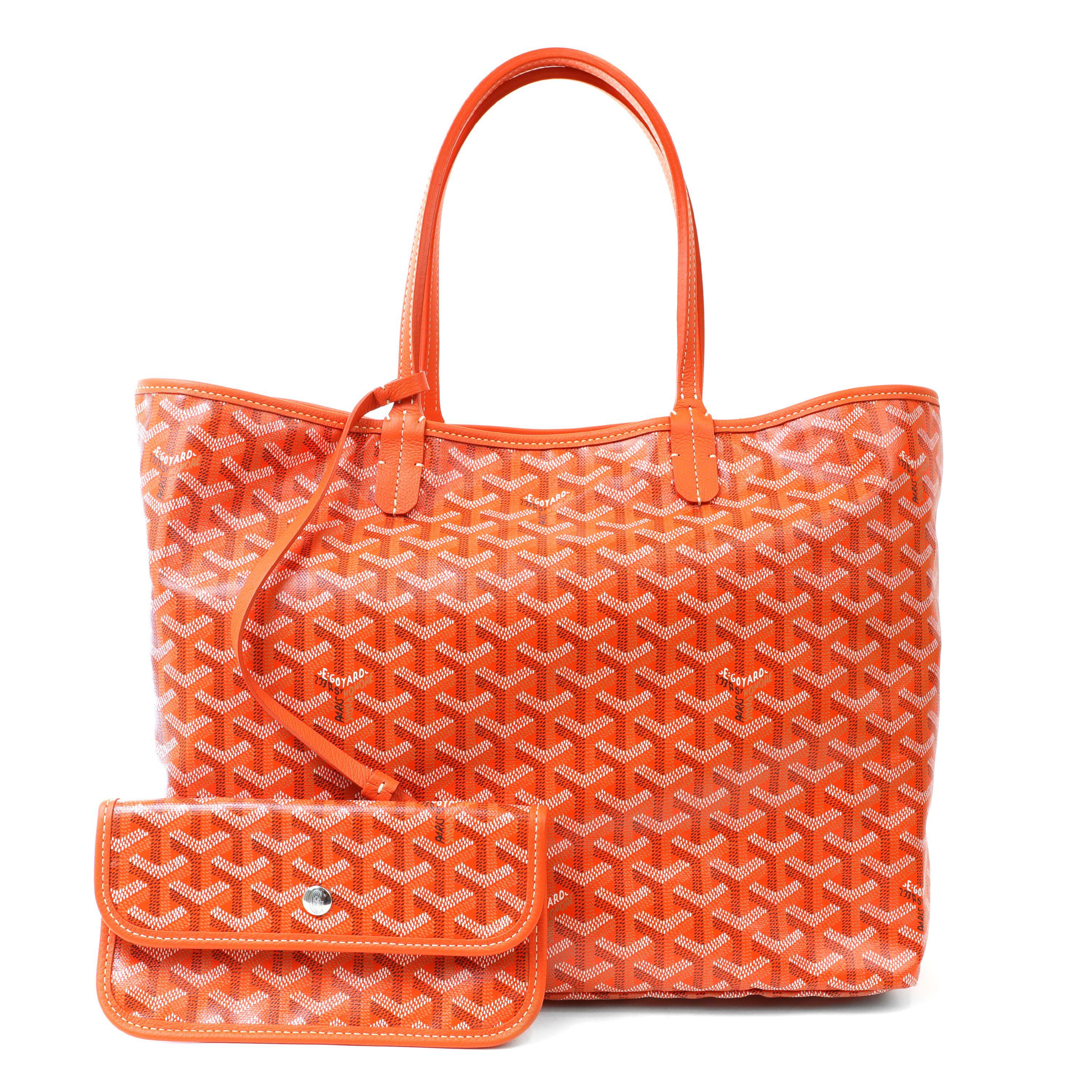 This authentic Goyard Orange St. Louis PM Striped Tote is in pristine condition, appearing never carried.  The iconic style features bright orange monogram coated hemp fabric with custom striping in white and aqua. Leather trim and handles with a