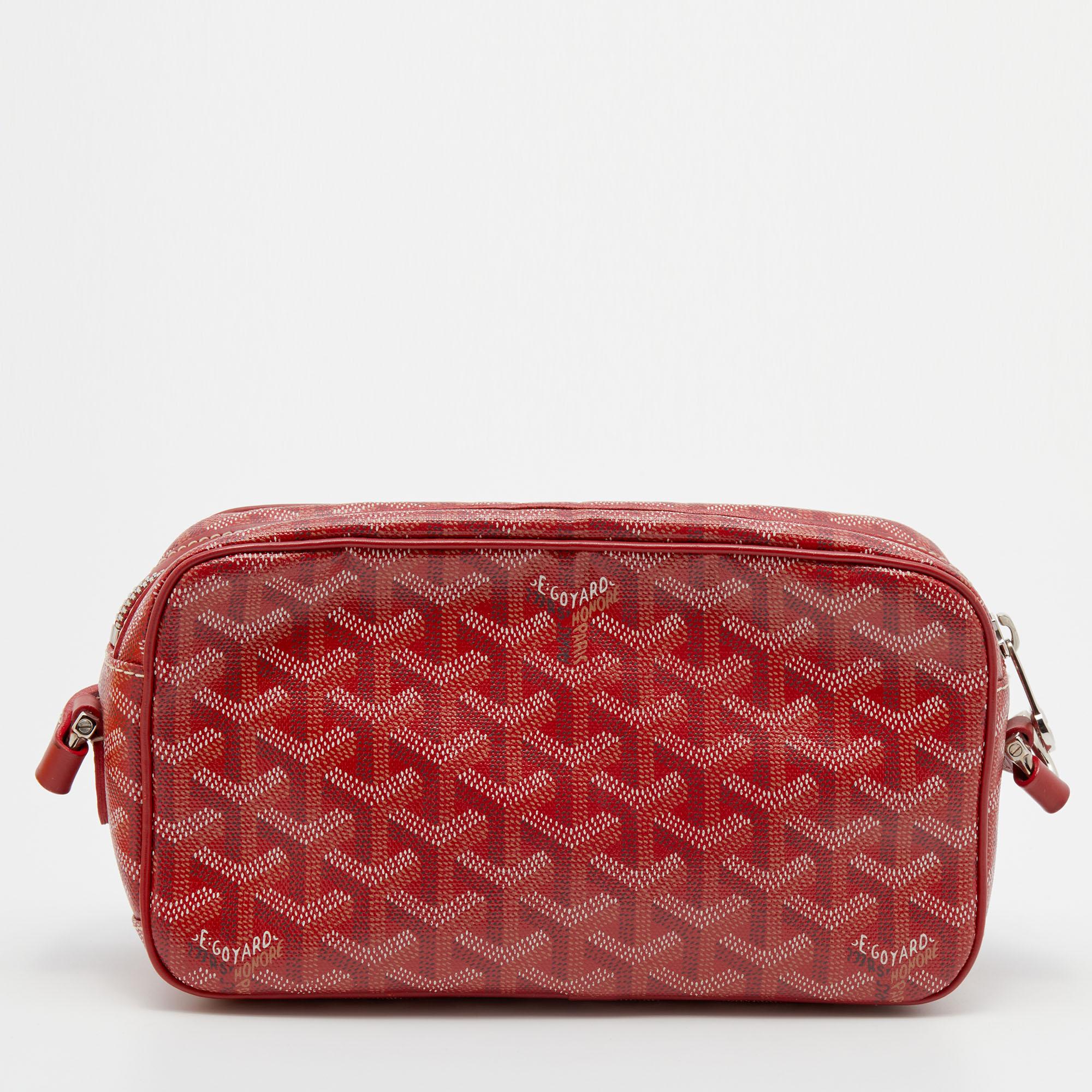 This crossbody bag from Goyard brings along a touch of luxury and immense style. It is crafted from the brand's signature Goyardine canvas and leather in red and is designed with a zip closure that leads to an interior equipped with ample space for