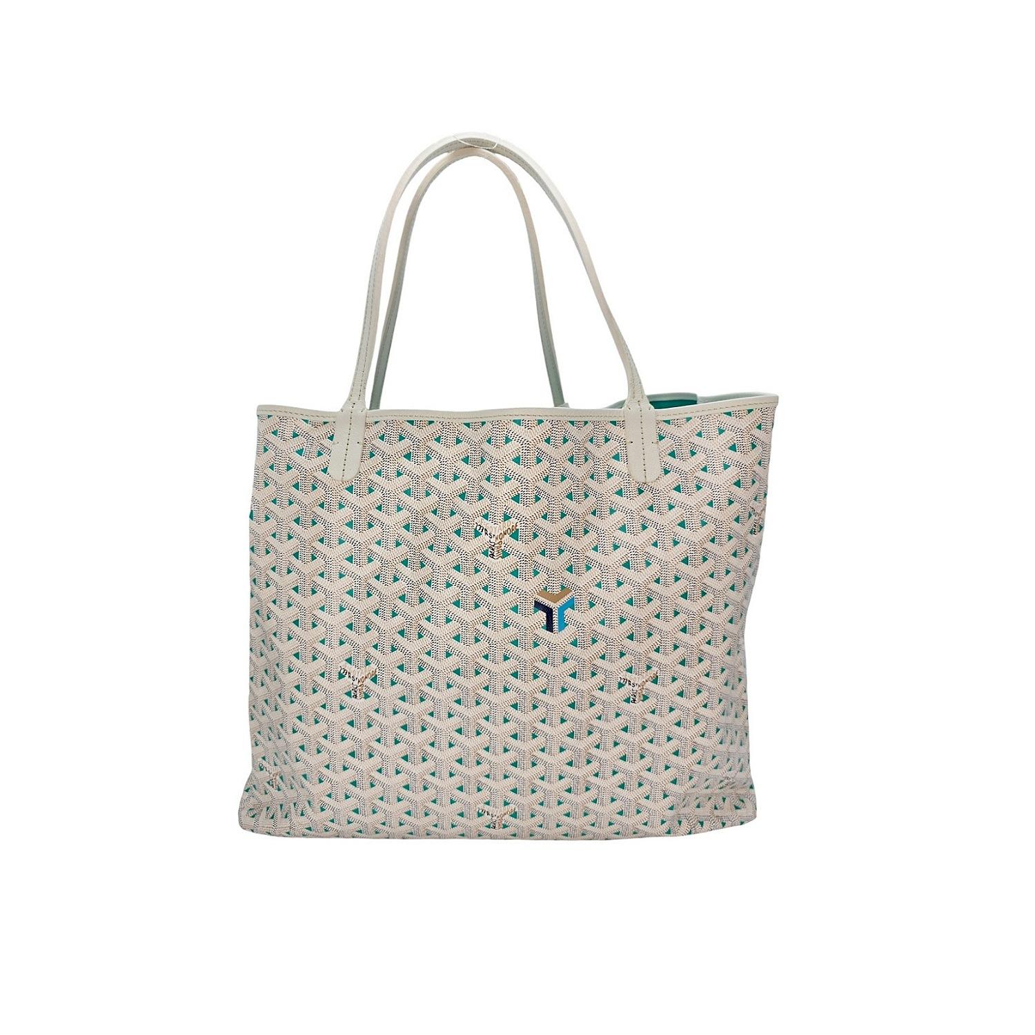Experience luxury at its finest with the Goyard Goyardine Saint Louis Claire Voie GM in White and Opaline. This special bag is the largest size of the line and features a classic relaxed tote structure. This reversible bag is crafted from Goyard