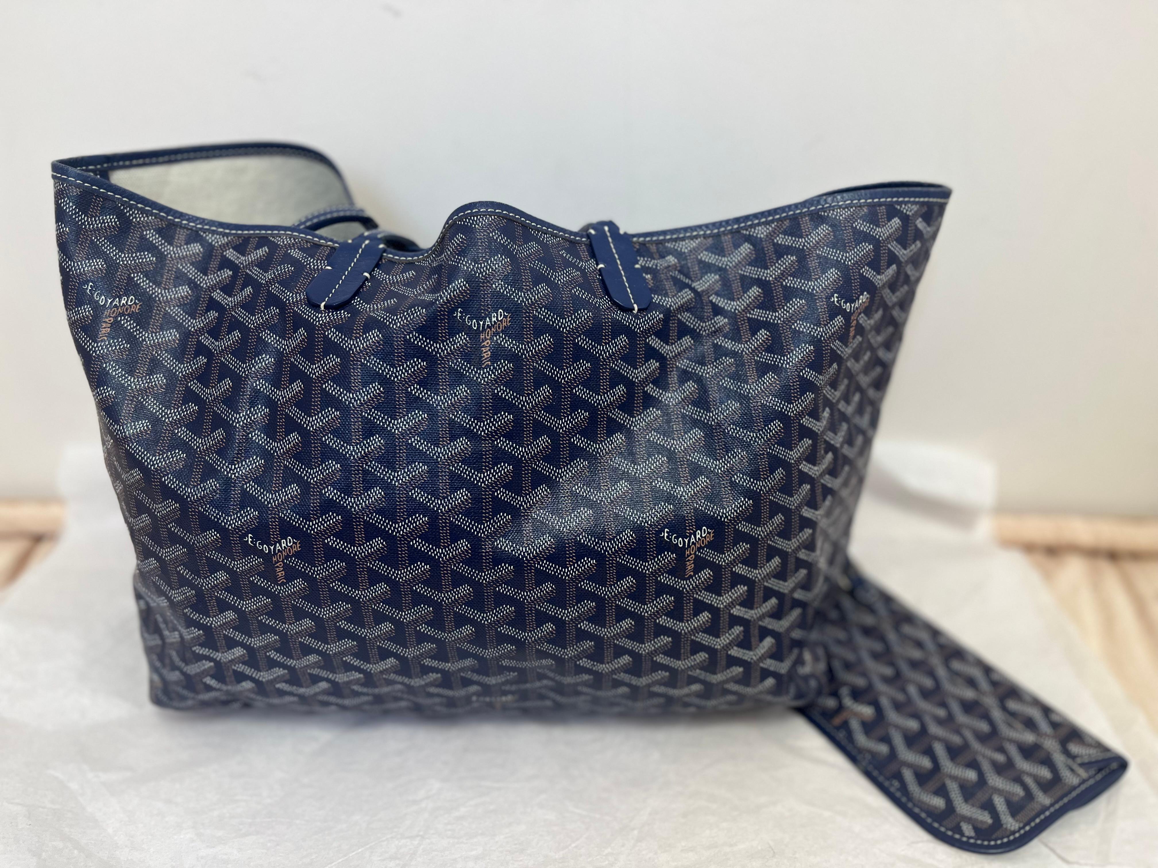 A favorite for both its distinct style, pattern and light weight (250 grams), this  blue Goyard tote with white and orange is made from Goyardine canvas and Chevroches calfskin.
This tote is unlined, and  has reversible potential.
The Goyard Saint