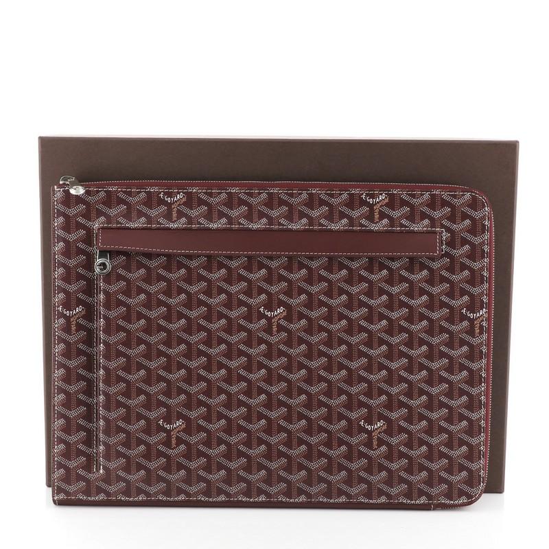This Goyard Sorbonne Document Case Coated Canvas, crafted in purple coated canvas, features an exterior zip pocket and silver-tone hardware. Its zip closure opens to a purple leather interior. 

Condition: Excellent. Slight creasing on opening,