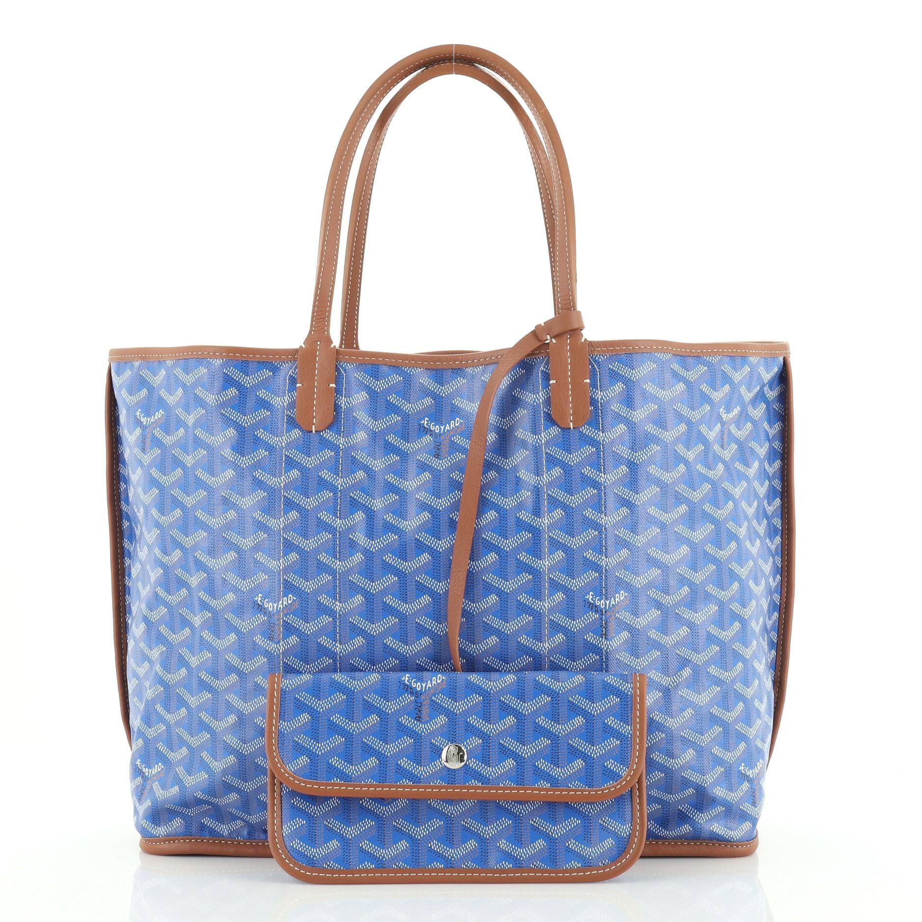 This Goyard St. Louis Pertuis Tote Coated Canvas PM, crafted from blue Goyard chevron coated canvas, features tall leather handles, leather trim, and silver-tone hardware. Its wide open top showcases a reversible neutral canvas interior.

Condition: