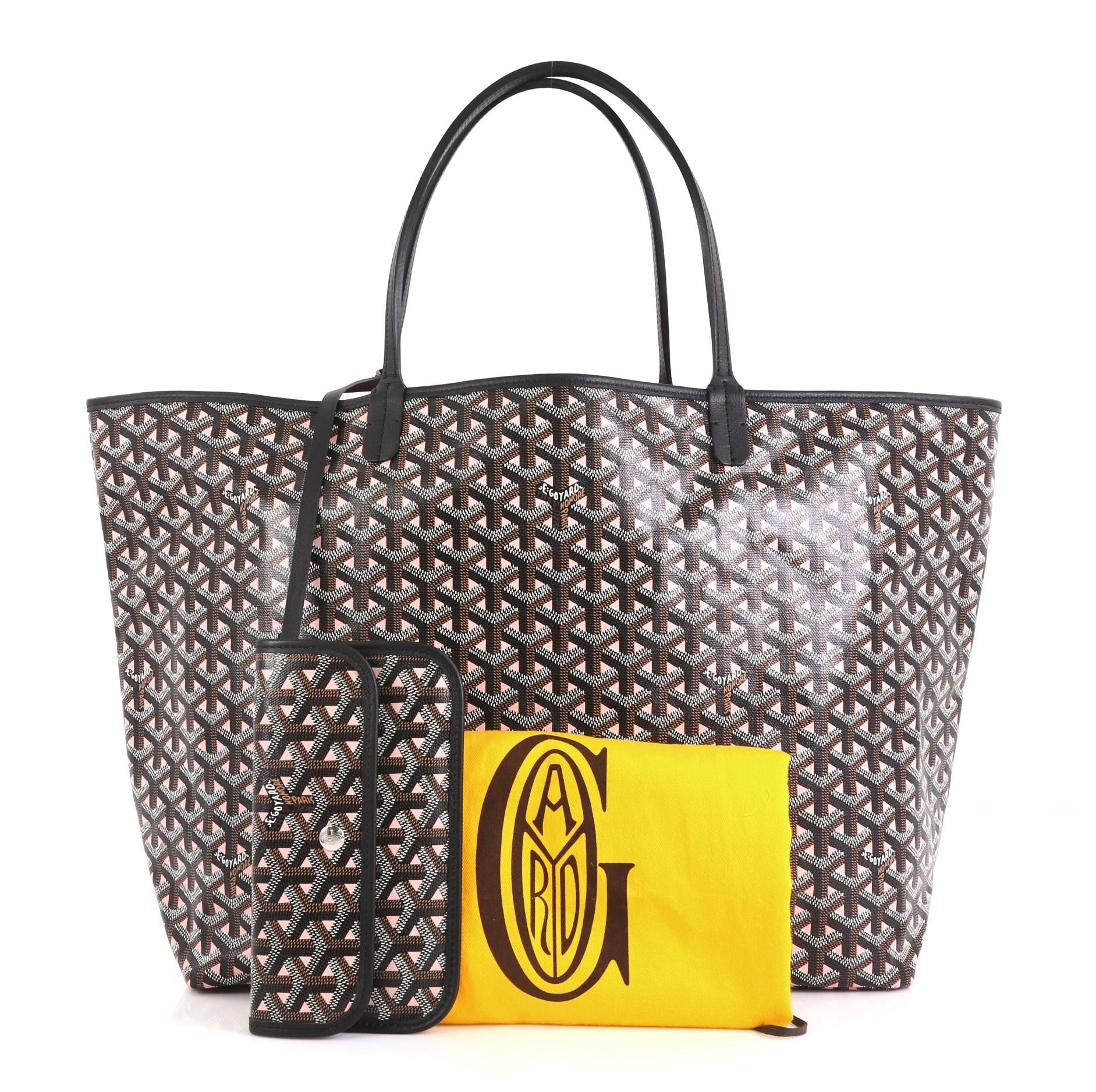 This Goyard St. Louis Tote Claire Voie Coated Canvas GM, crafted in brown and pink coated canvas, features flat leather handles and silver-tone hardware. Its wide open top showcases a pink canvas interior. 

Condition: Excellent. Minor wear on base