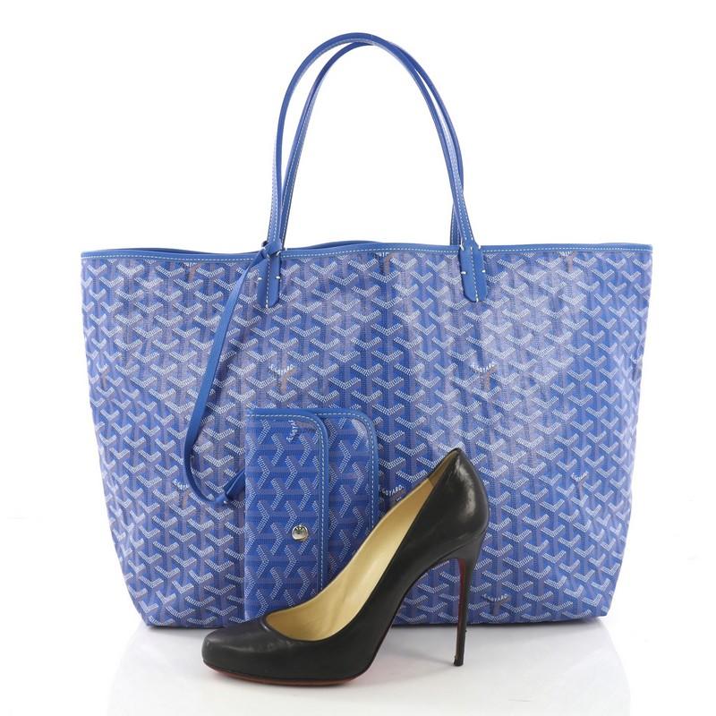 This Goyard St. Louis Tote Coated Canvas GM, crafted in blue coated canvas, features flat leather handles and silver-tone hardware. Its wide open top showcases a beige canvas interior. **Note: Shoe photographed is used as a sizing reference, and