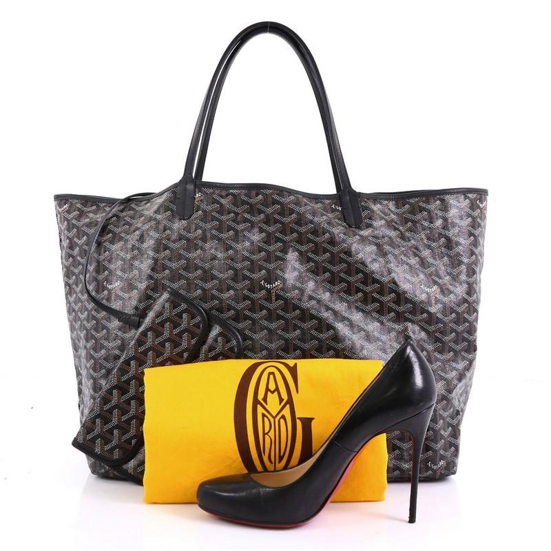 This Goyard St. Louis Tote Coated Canvas GM, crafted in black, brown and white coated canvas, features flat leather handles and silver-tone hardware. Its wide open top showcases a light beige fabric interior. **Note: Shoe photographed is used as a