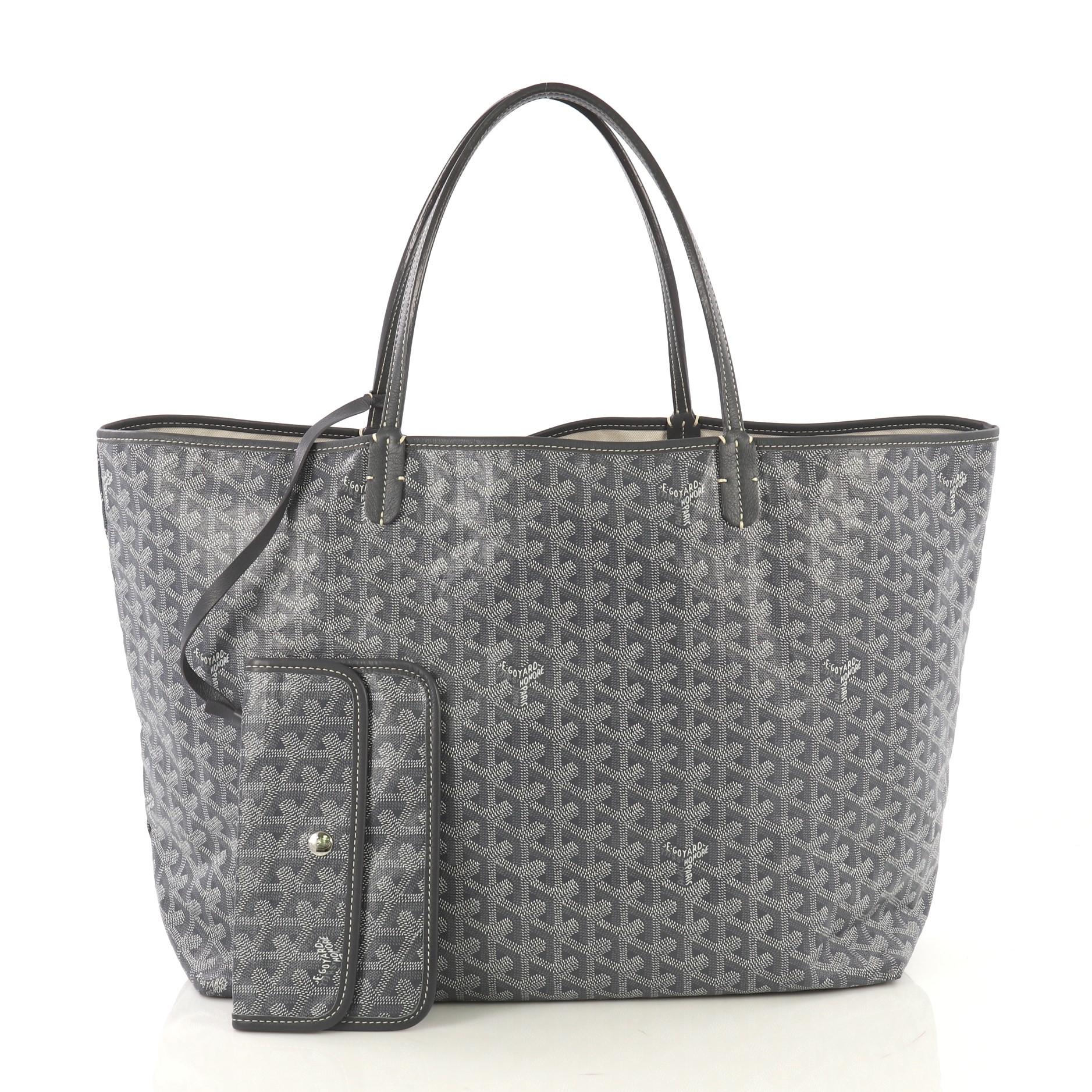 This Goyard St. Louis Tote Coated Canvas GM, crafted in gray coated canvas, features flat leather handles and silver-tone hardware. Its wide open top showcases a beige canvas interior. 

Condition: Excellent. Slight creasing on exterior, minor wear