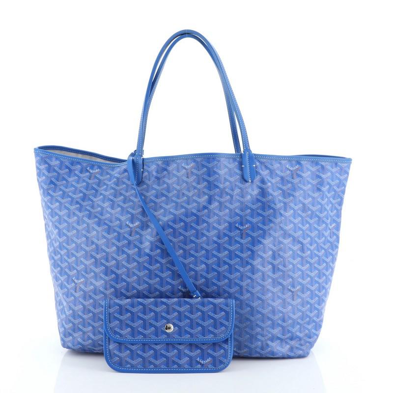 This Goyard St. Louis Tote Coated Canvas GM is a classic bag with its monogram print from the brand's central letter. Crafted from blue coated canvas, it features dual slim leather handles, leather trim, and silver-tone hardware. Its wide open top