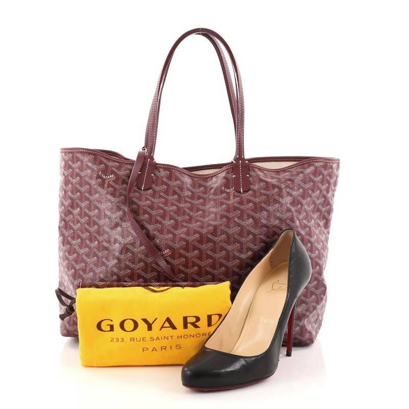 This authentic Goyard St. Louis Tote Coated Canvas PM is a spacious bag ideal for everyday excursions. Crafted from the popular and traditional purple Goyard chevron coated canvas, this tote features long flat leather top handles, stand-out contrast