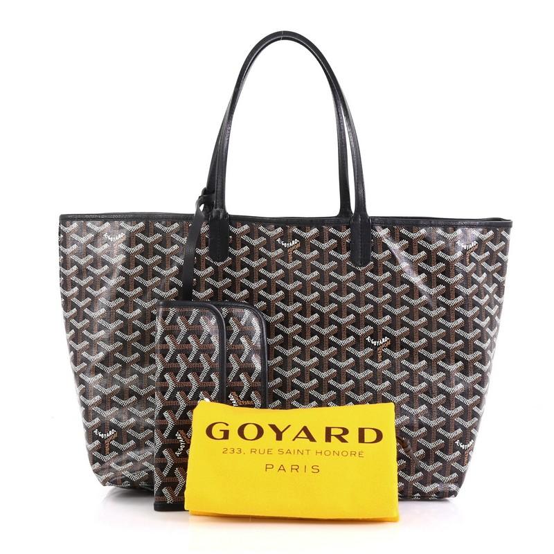 This Goyard St. Louis Tote Coated Canvas PM, crafted in black coated canvas, features flat leather handles, leather trim, and silver-tone hardware. Its wide open top showcases a beige canvas interior. 

Condition: Excellent. Slight cracking on