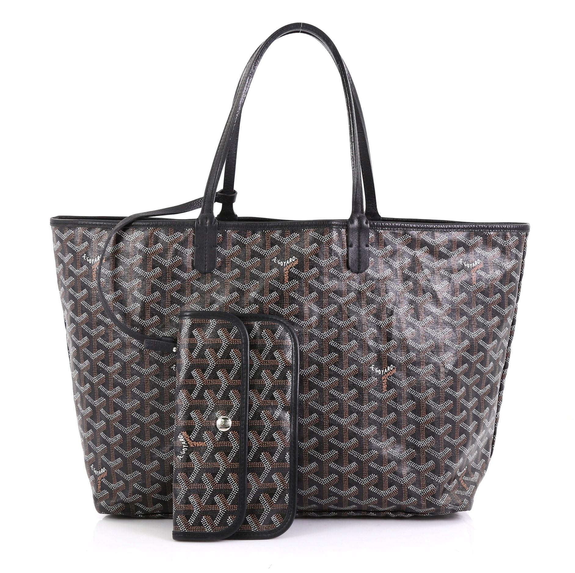 This Goyard St. Louis Tote Coated Canvas PM, crafted from brown and white coated canvas, features dual slim leather handles, leather trim, and silver-tone hardware. Its wide open top showcases a beige canvas interior. 

Condition: Great. Minor wear