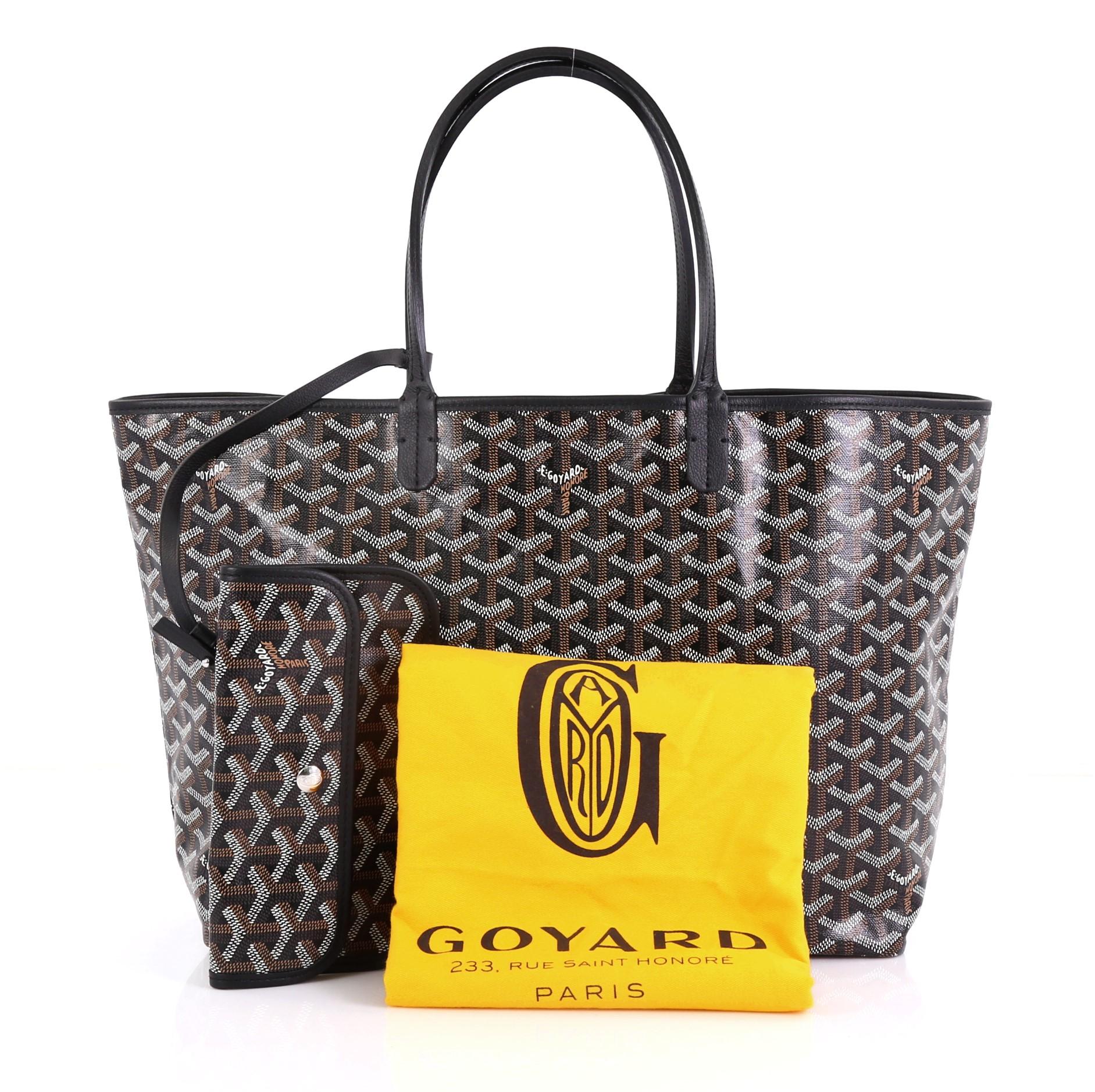 This Goyard St. Louis Tote Coated Canvas PM, crafted from black and brown coated canvas, features dual slim leather handles, leather trim, and silver-tone hardware. Its wide open top showcases a beige canvas interior. 

Condition: Excellent.