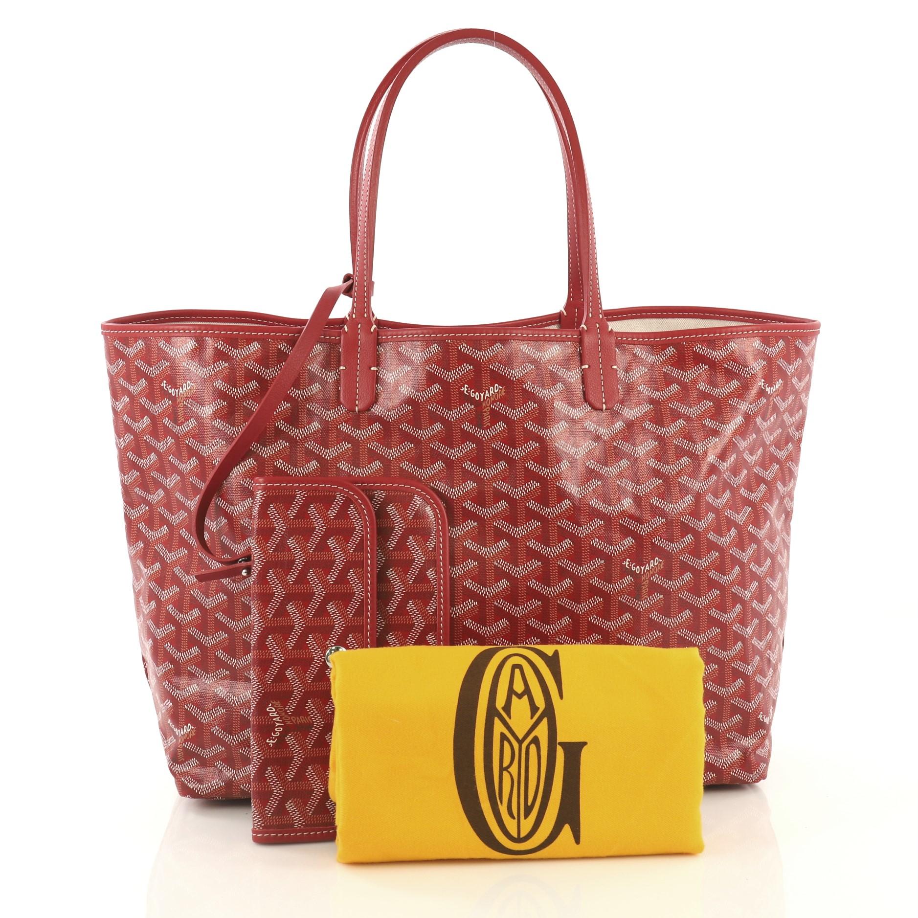 This Goyard St. Louis Tote Coated Canvas PM, crafted from red and white coated canvas, features dual slim leather handles, leather trim, and silver-tone hardware. Its wide open top showcases a beige canvas interior. 

Condition: Excellent. Slight