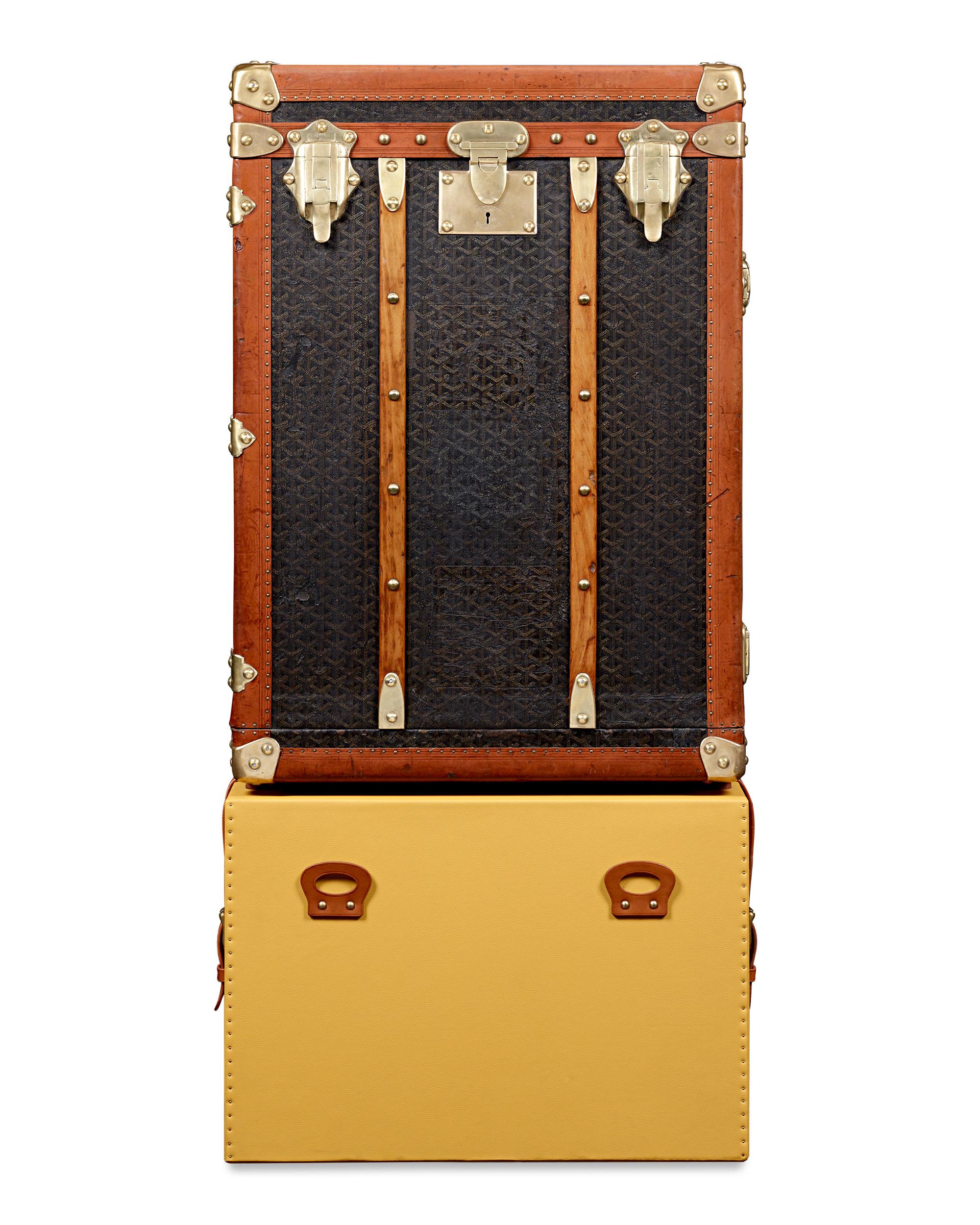This early 20th-century Goyard travel trunk with a fitted bar stands as a testament to the splendor of its era. Adorned with the iconic Goyard chevron pattern meticulously hand-painted in earth tones of brown and white, it pays homage to the brand's
