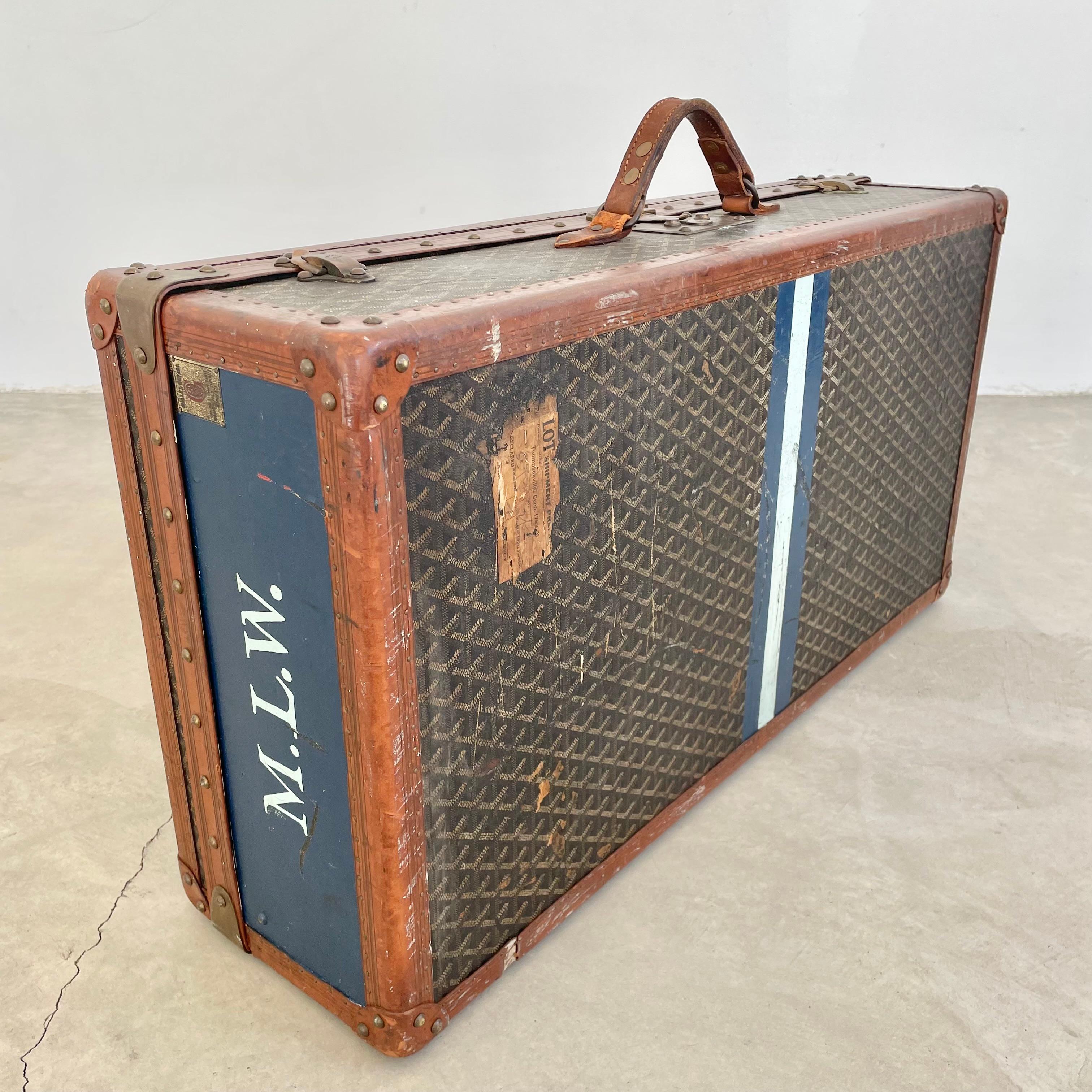 Classic vintage Goyard trunk. Wooden frame wrapped in the iconic Goyard canvas print with saddle leather and brass hardware. Incredible patina and coloring to leather and canvas. Accents of blue and white paint give this trunk amazing charachter.