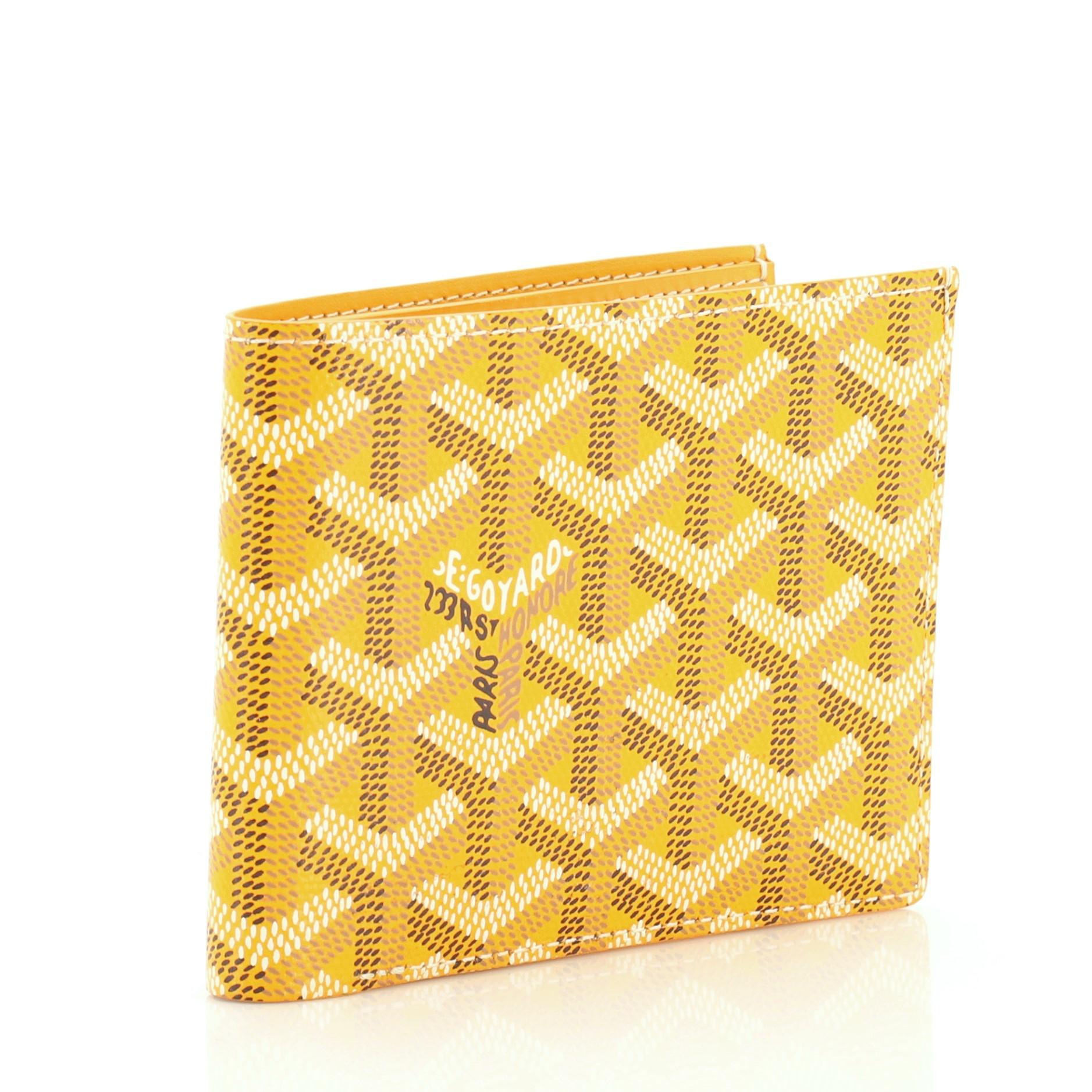 This Goyard Victoire Wallet Coated Canvas, crafted from yellow coated canvas, features a folder style silhouette. It opens to a yellow leather interior with multiple card slots and slip pocket. 

Estimated Retail Price: $1,020
Condition: Excellent.