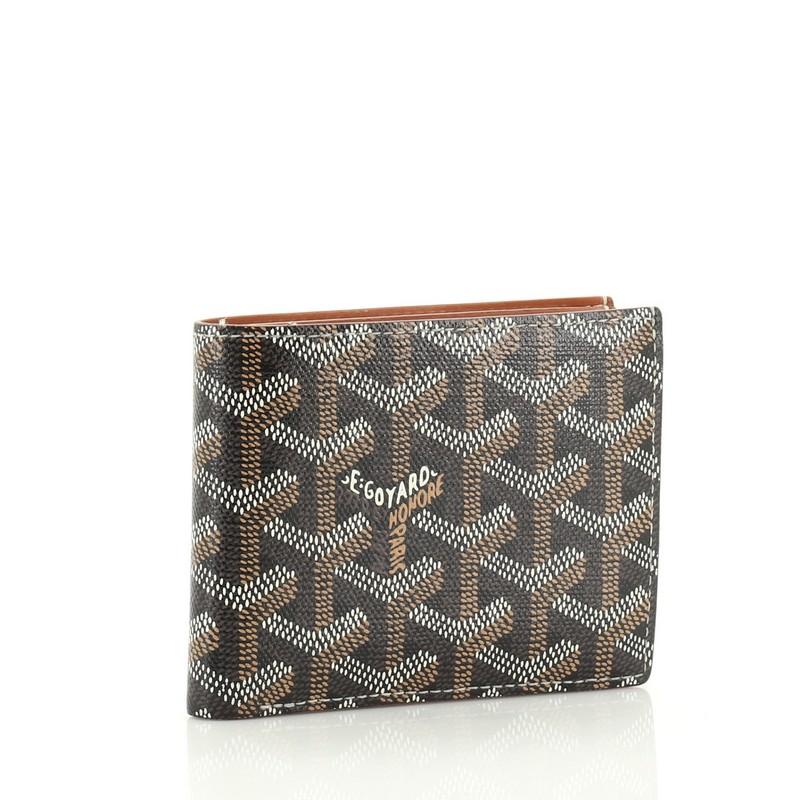 This Goyard Victoire Wallet Coated Canvas, crafted from brown coated canvas, features a folder style silhouette. It opens to a brown leather interior with multiple card slots and slip pocket. 

Estimated Retail Price: $1,020
Condition: Very good.