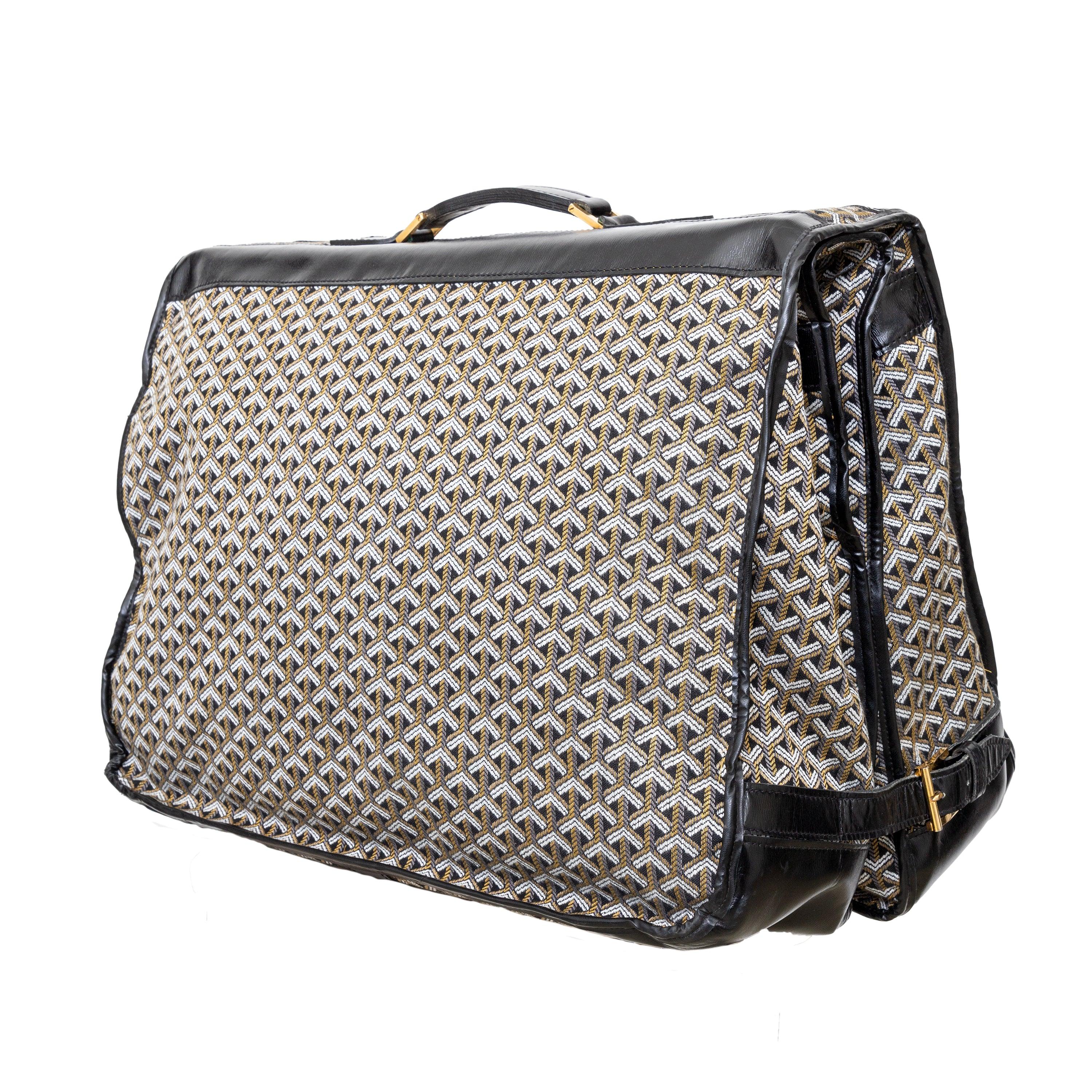 Travel in style with the Goyard Vintage Garment Bag from the 1970s. Made from fabric in the iconic herringbone weave of the brand, this rare bag features a garment carrying section, top handles for easy carrying, and a convenient hook for hanging in