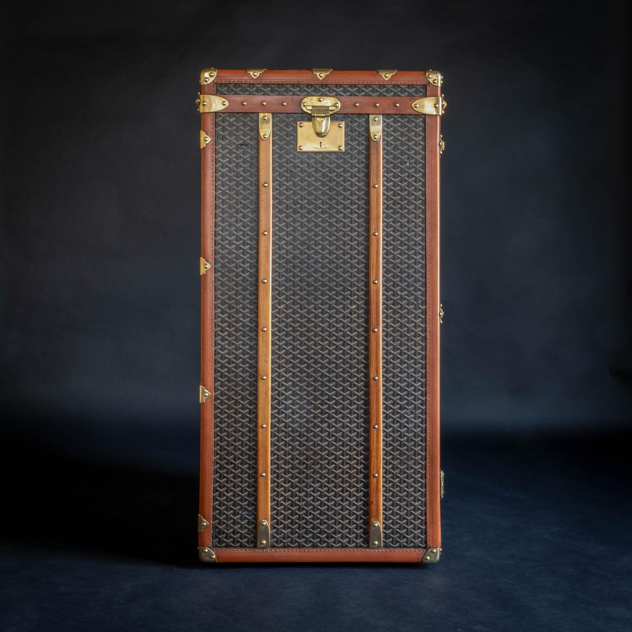 An unusual Goyard wardrobe trunk with original chevron pattern canvas covering, brass fittings and original cotton lined interior providing hanging space. Circa 1920.

The proportion of the trunk means that, if it was laid on it’s back, it would