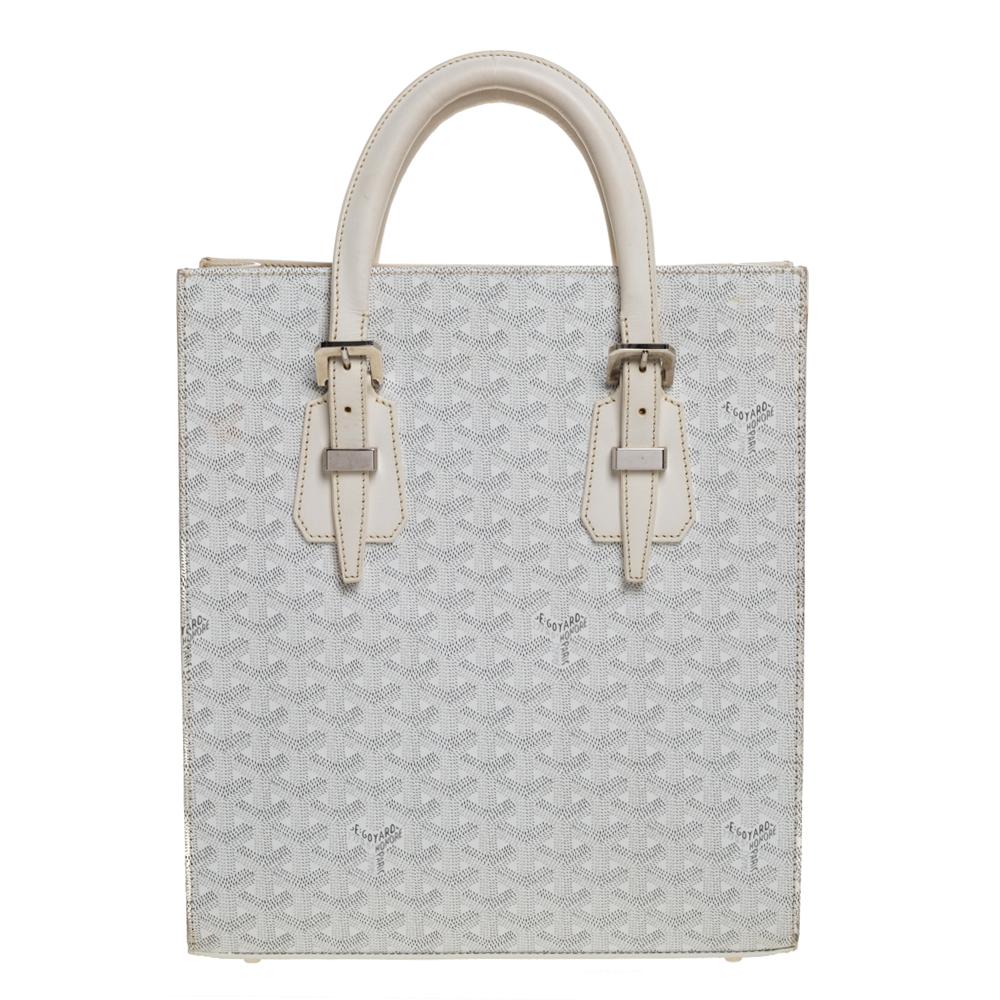 Goyard's Goyardine pattern adds a luxurious touch to its bags and this Comores PM tote will brighten up your looks! This tote features the signature pattern on the canvas exterior in a white shade. Accented with leather trim, this bag comes with