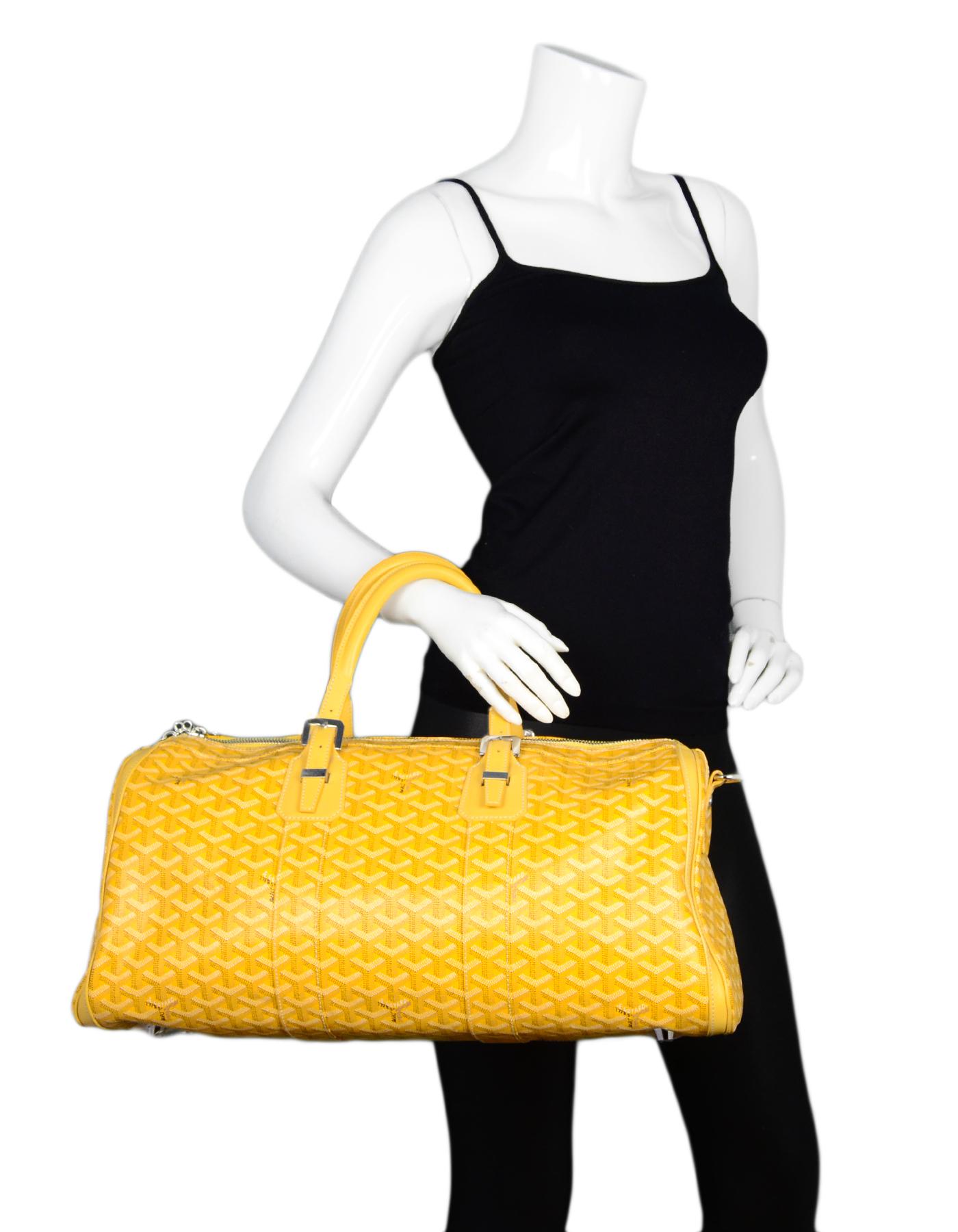 Goyard Yellow Goyardine Canvas/Leather Croisiere 50 Duffle Bag

Made In: France
Color: Yellow, black, white
Hardware: SIlvertone
Materials: Coated canvas, leather, metal
Lining: Yellow canvas
Closure/Opening: Zip top
Exterior Pockets: None
Interior