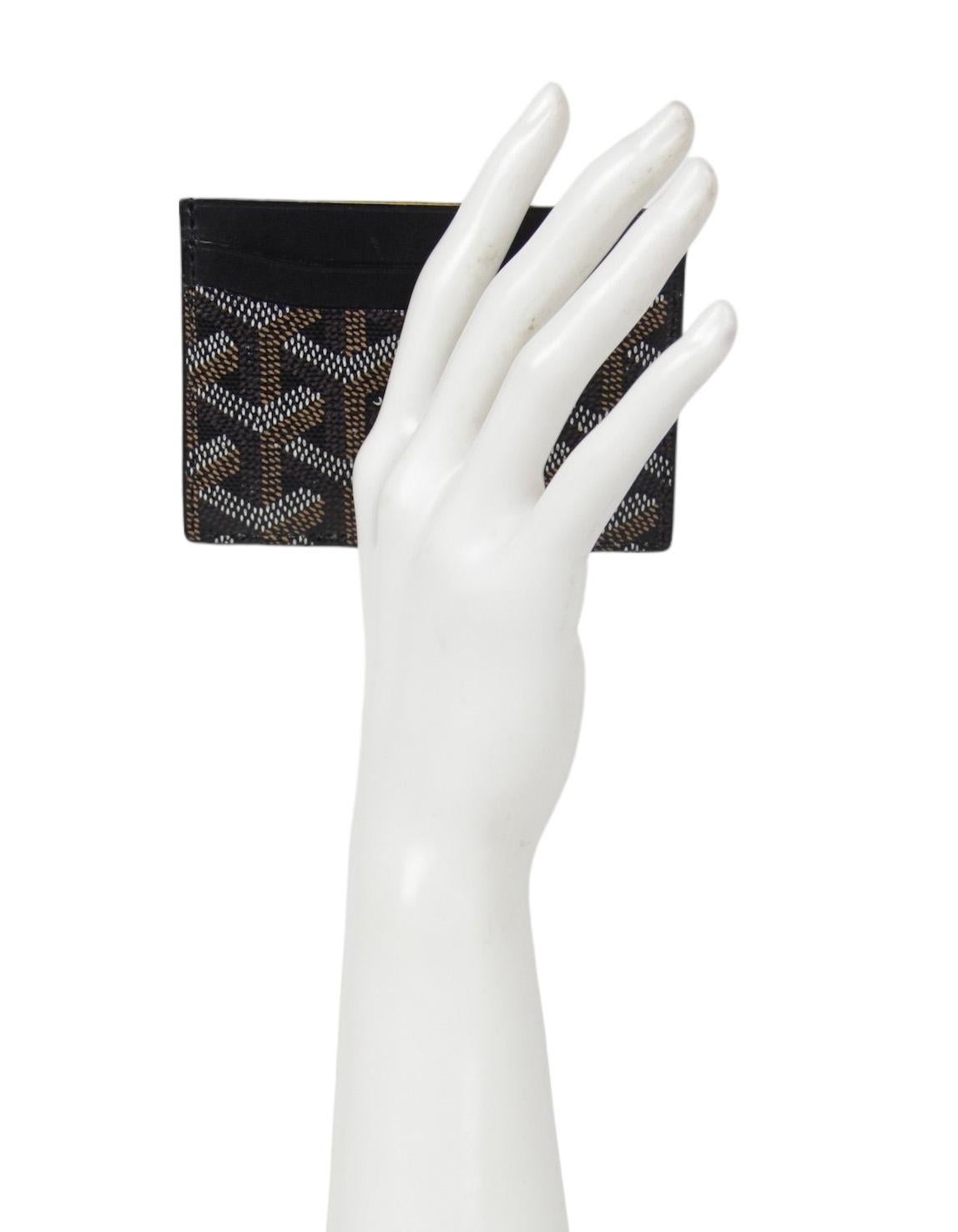 Goyard Black Goyardine Canvas Saint Sulpice Card Holder

Color: Black
Materials: Canvas and leather 
Four credit card slots and middle card/compartment slot
Overall Condition: Excellent with light wear


Measurements:
4.25