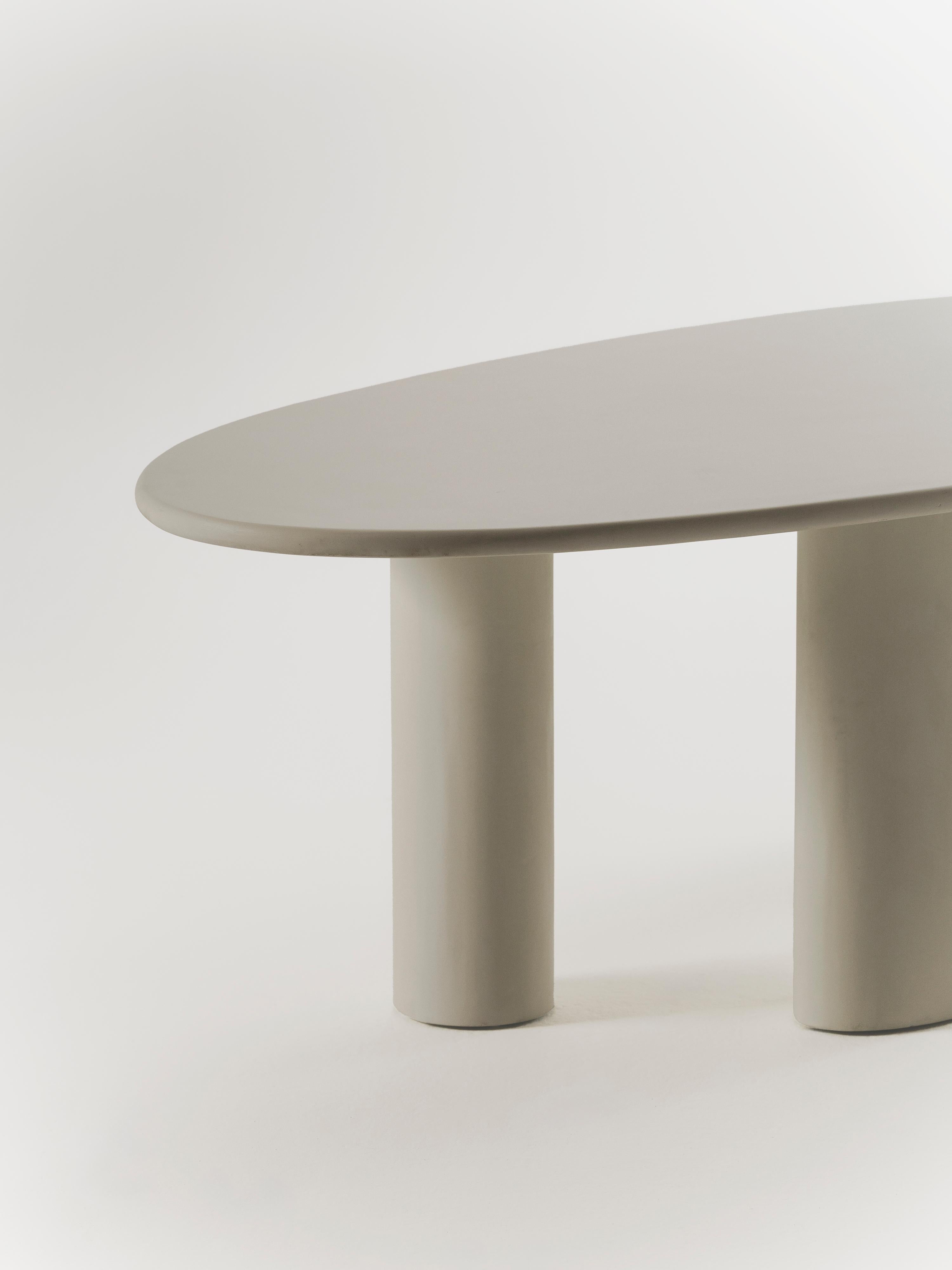 Handcrafted in Spain by expert artisans, this oval-shaped dining table from Marlot Baus combines timeless design with modern craftsmanship. Each piece is carefully made using our signature microcement technique, layered by hand to achieve a smooth,