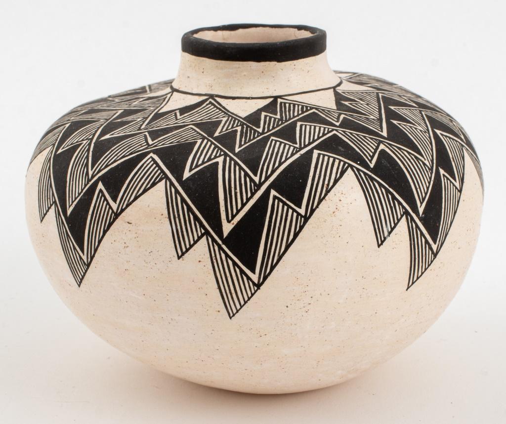 Grace Chino (Acoma, 1929-1994) hand-built pottery vase, 1987, with hand-painted angular geometric design, black borders to the tapered neck and lip, the vessel with a rounded foot, signed 