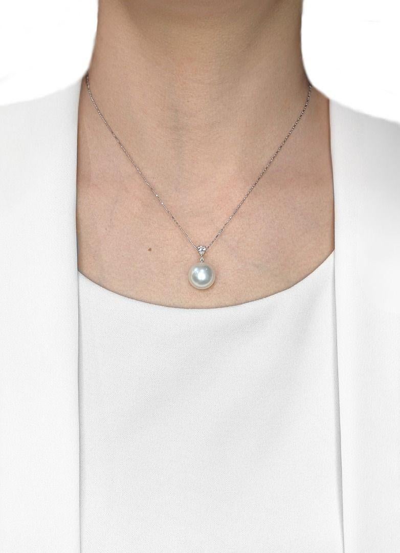 Adorn your neckline with this graceful pendant, showcasing a magnificent 13mm round South Sea pearl, celebrated for its pure white luster and exceptional glow. Expertly set in radiant 18K white gold, this exquisite pearl is beautifully crowned by a