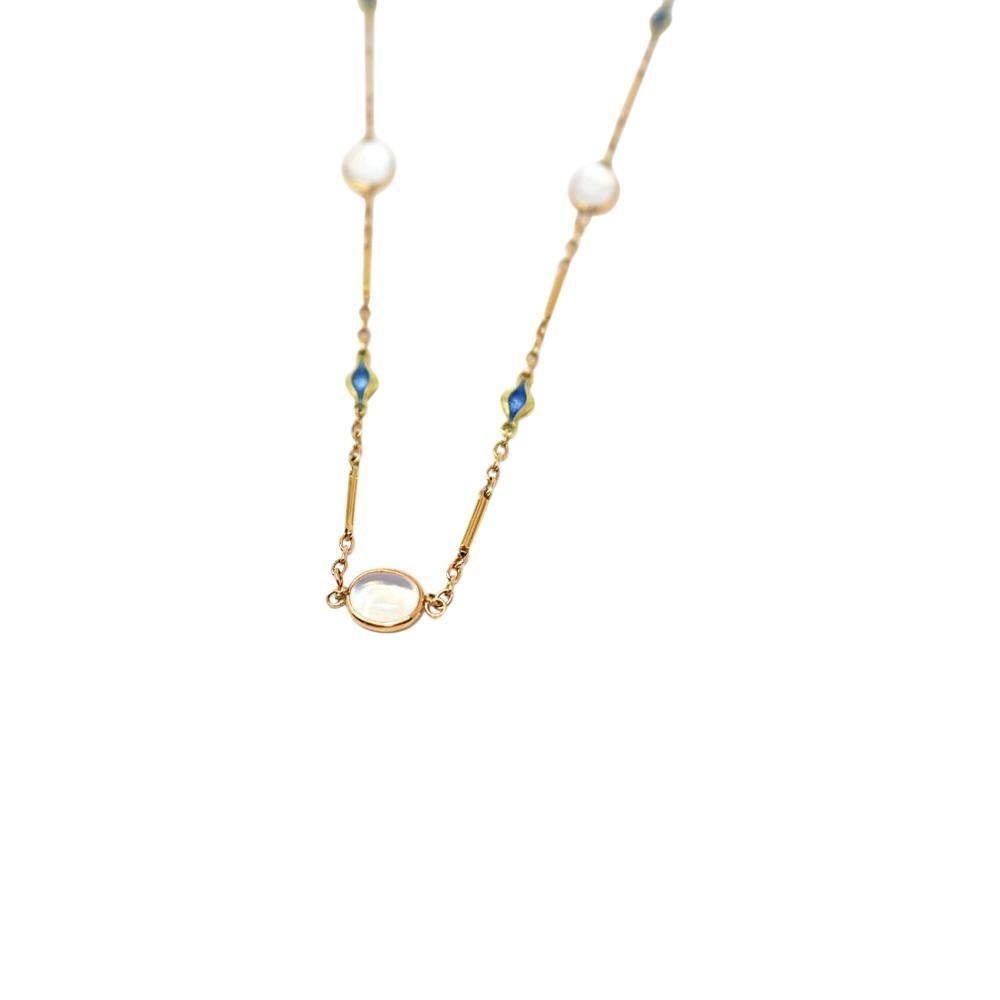 Link style necklace featuring five oval moonstone cabochon stations, bezel set in a thin gold frame

Each measuring approximately 9.0 x 6.5 mm; transparent with moderate adularescence

Alternating with fluted blue enamel accents

Tested as 14 karat