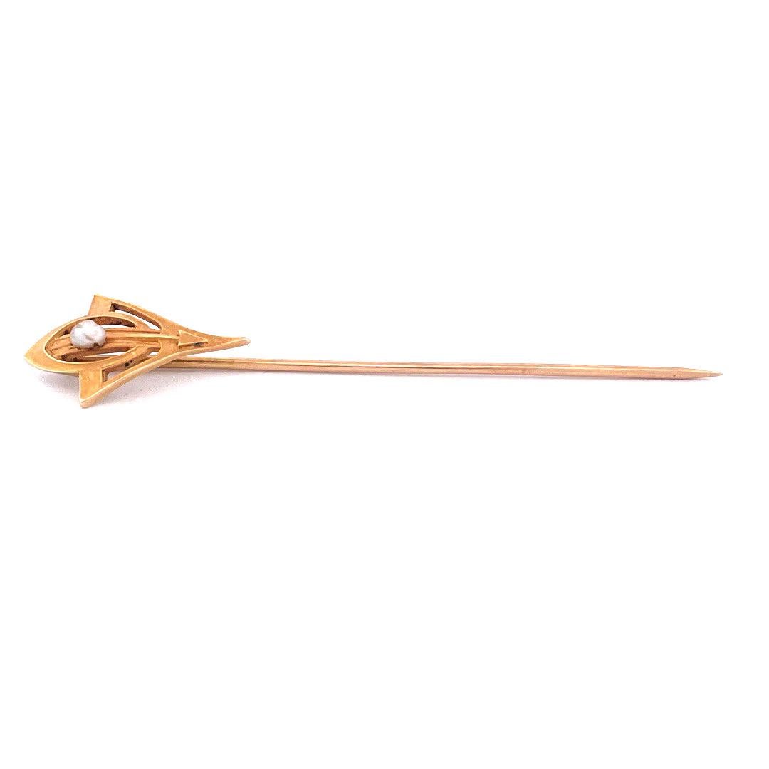 Embrace grace and elegance with this 14k yellow gold arrow pearl pin. The pin showcases a unique combination of an arrow and oval-shaped crown design. At the center of the oval crown rests a lustrous pearl. Weighing just 1.4 grams, this lightweight